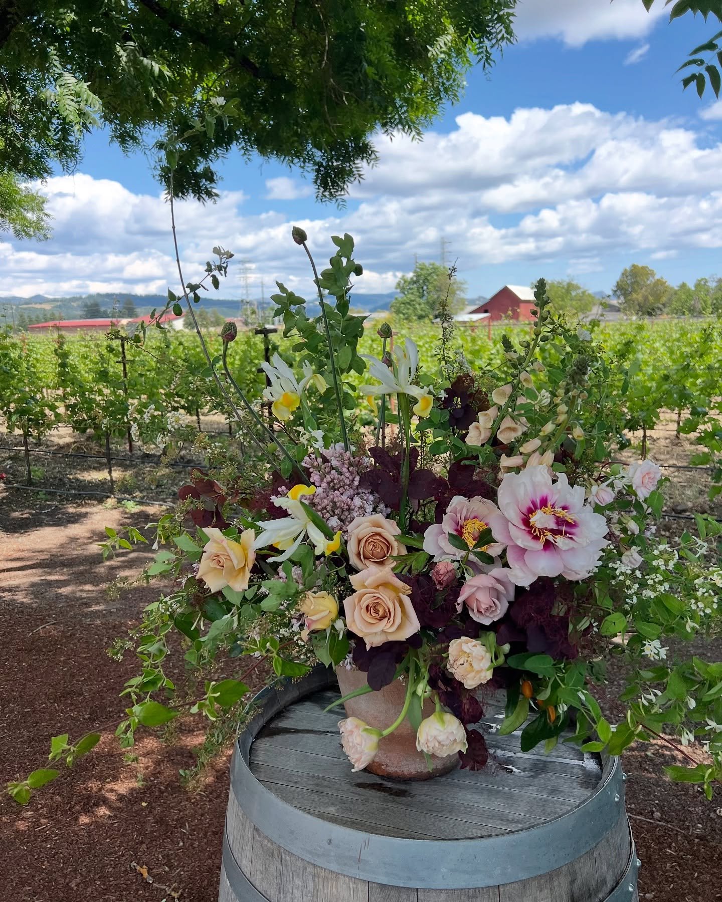 I loved this arrangement. All of my favorite spring things - spirea, honeysuckle, lilac, tree peonies, SMOKEBUSH, tulips, honey Ds... Her journey from the studio to the venue (surviving the wind after a few tumbles 🫠) and ending at my parent&rsquo;s