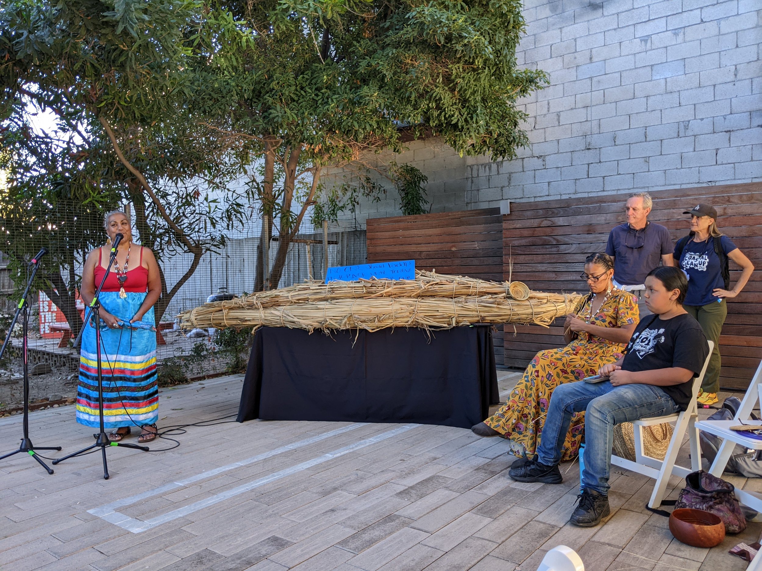 Tina Calderon singing alongside Tule boat. /Photo: Jenna Didier