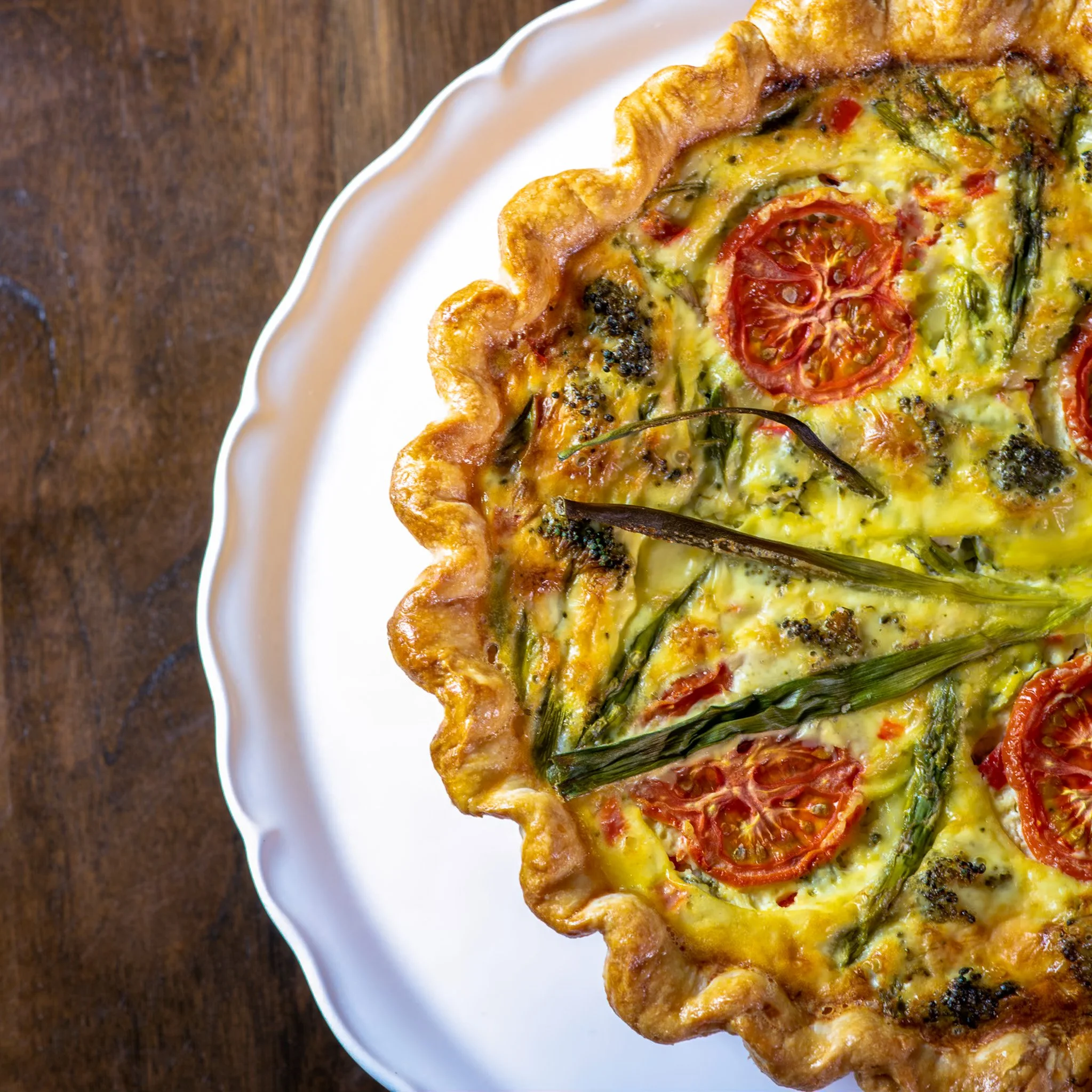 picture of a veggie quiche on a white plate