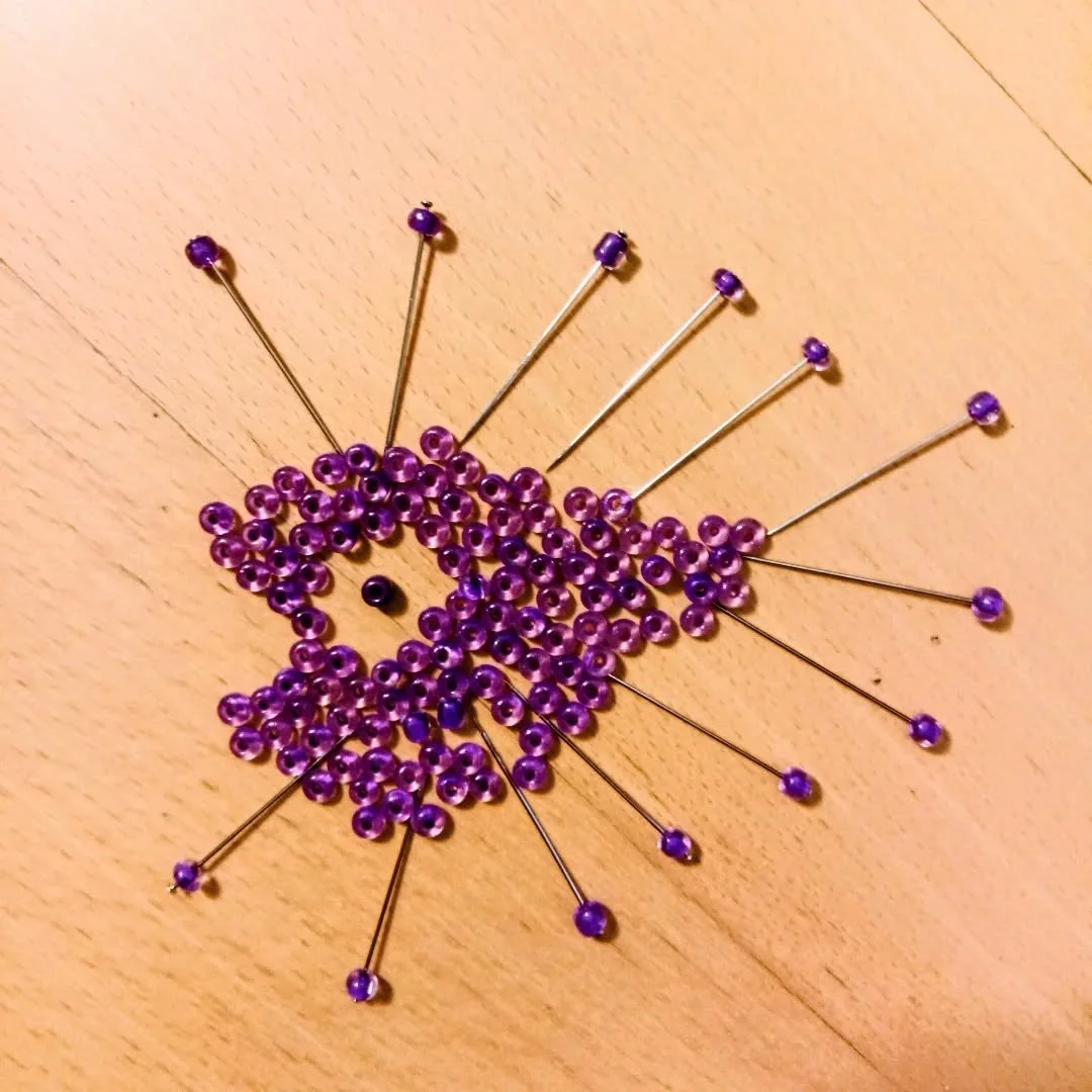 These two works ended up speaking to each other in unexpected ways.

The small spiked fish was never planned as a finished work. I made it for fun while preparing materials for the larger sculpture &mdash; using the same beads, pins, and components t