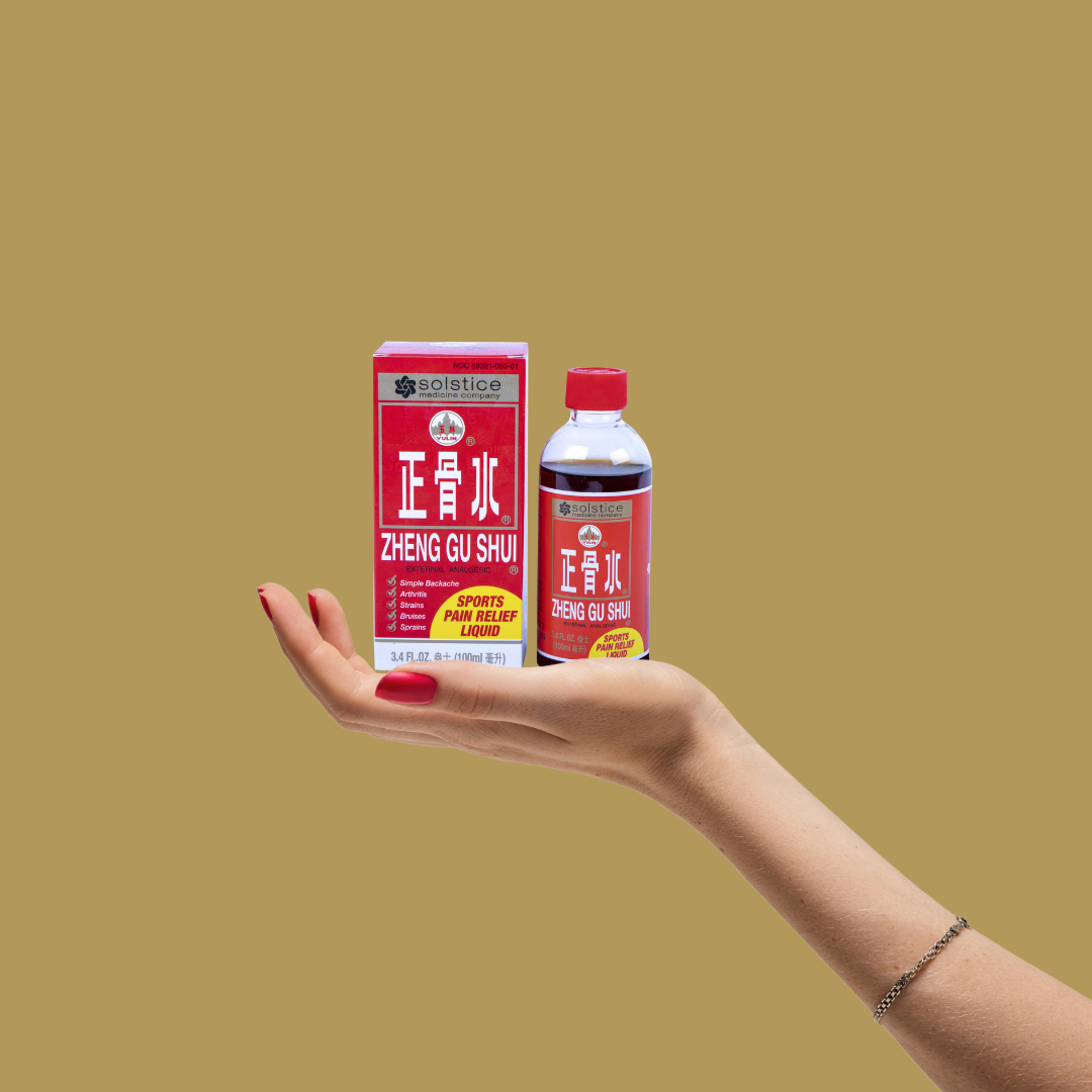 Arm holding a bottle of Zheng Gu Shui