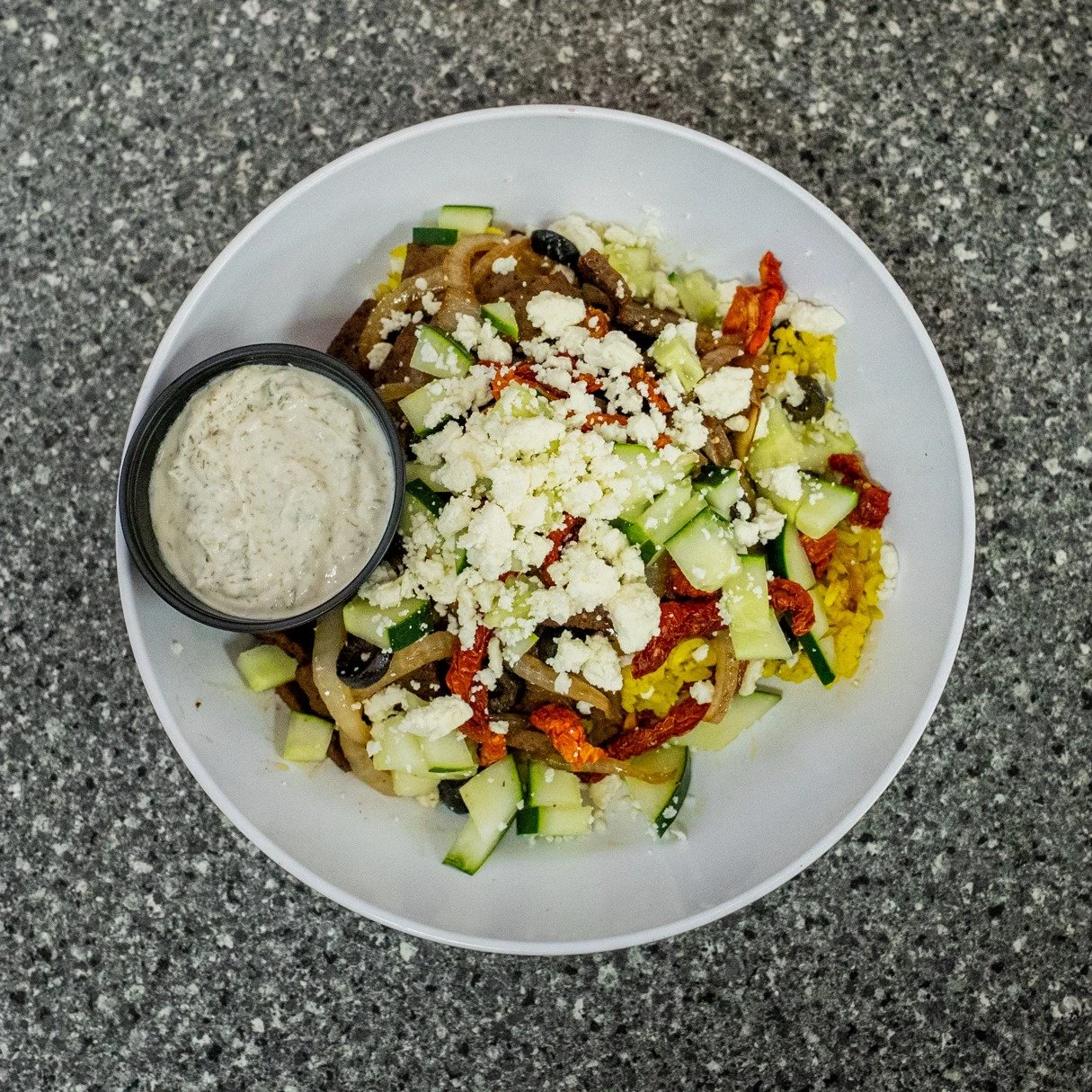 Yum! 🥗
Our Greek Salad is loaded with fresh romaine, gyro meat, sun-dried tomatoes, feta, cucumbers, olives, peppers, and onions&mdash;served with a side of Greek dressing. Fresh, flavorful, and always a favorite.
