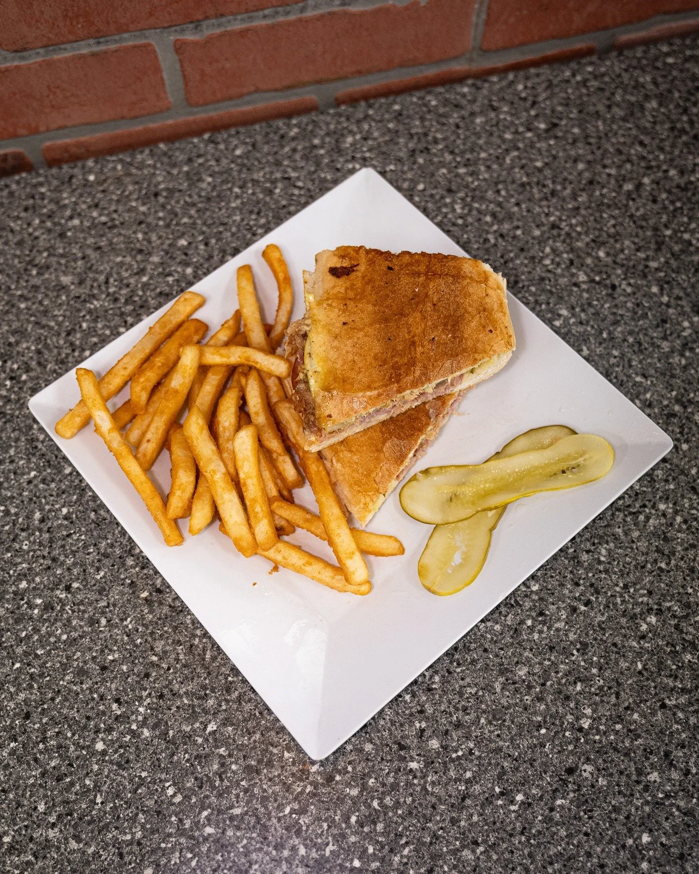 The Cubano that means business. 🥪
An authentic South Tampa recipe stacked with ham, salami, roasted pork, Swiss cheese, pickles, mustard, and mayo&mdash;pressed on fresh Cuban bread until golden and melty.