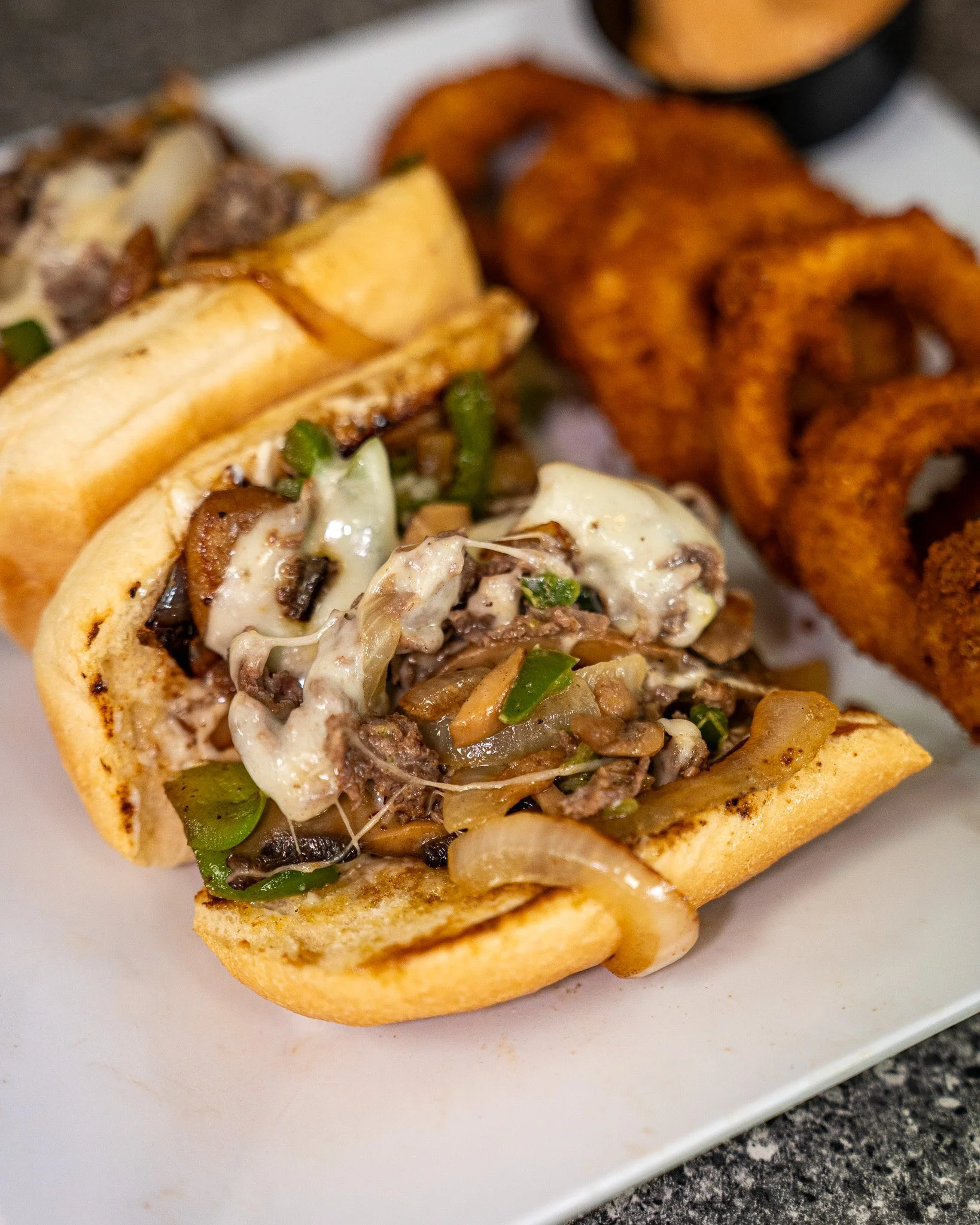 Loaded, melty, and made to order. 🥖
Our Philly features grilled steak or chicken topped with saut&eacute;ed mushrooms, peppers, onions, melty Provolone, and mayo&mdash;simple, savory, and always satisfying.