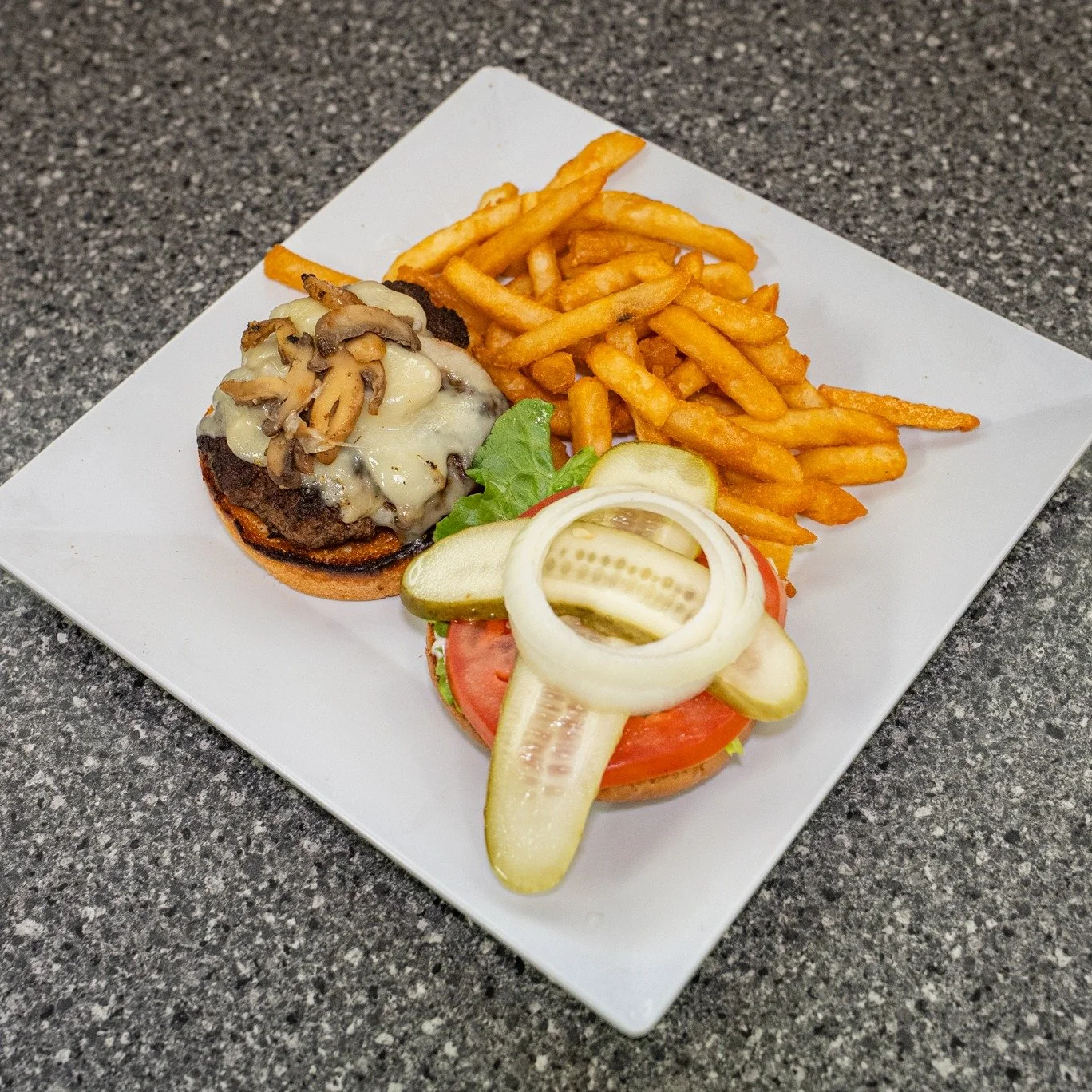 A good burger done right with all the fixings 🍔 Hot off the grill and ready for you!
