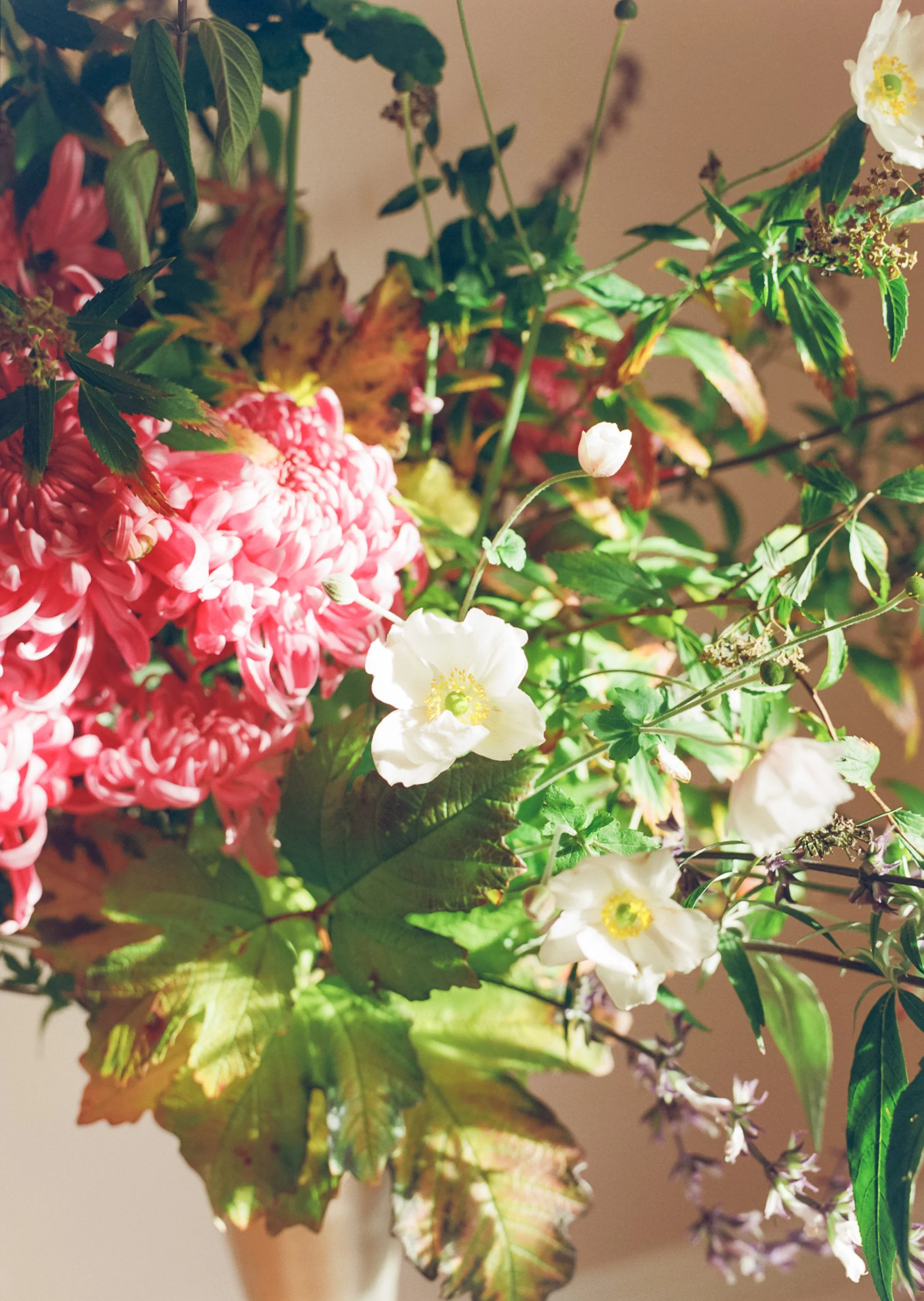 Arrangement by Hattie McLean with pink dahlias in tall silver vase