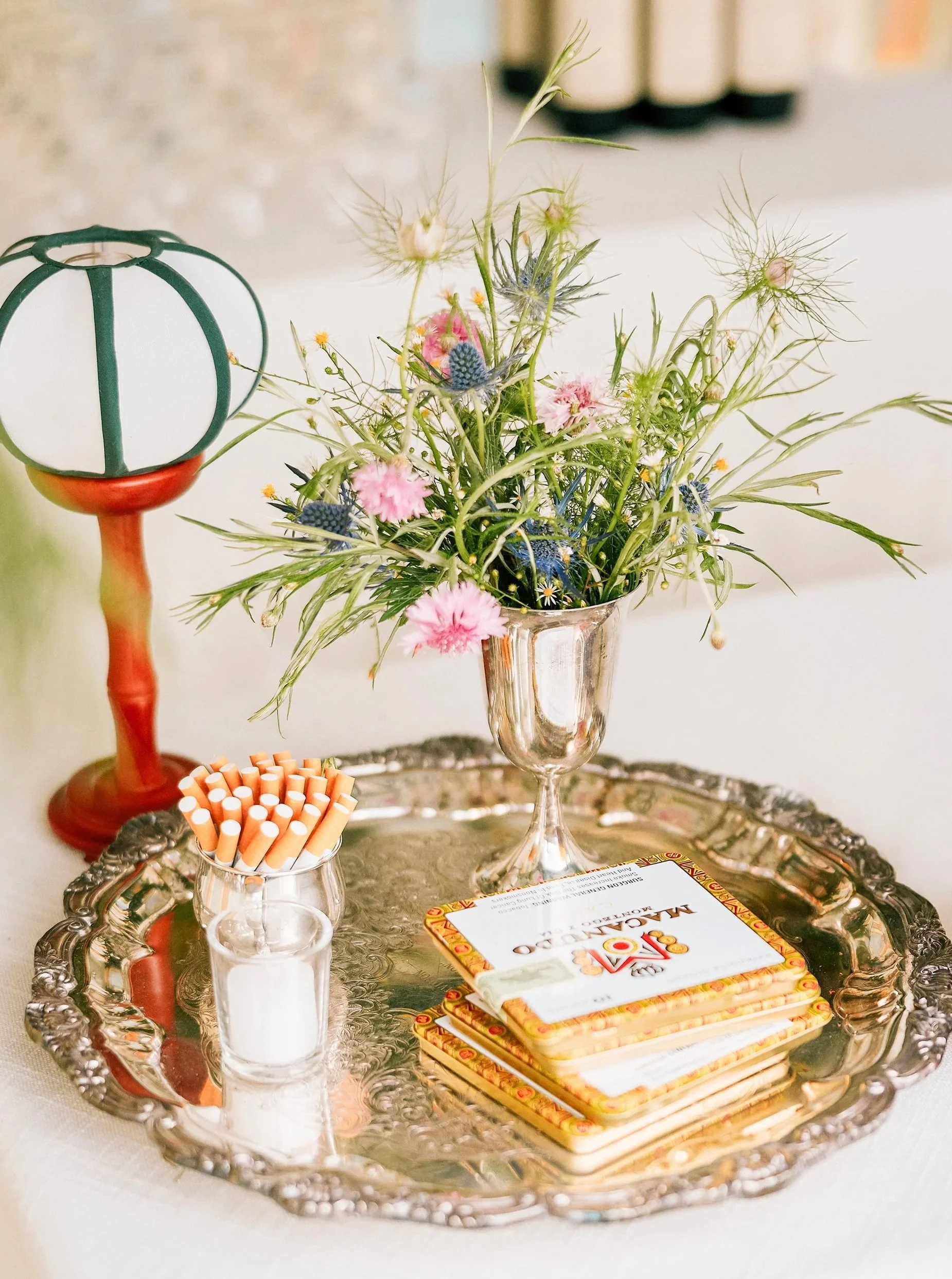 Arrangement by Hattie McLean with cigarettes on a silver tray and japanese bar lamp