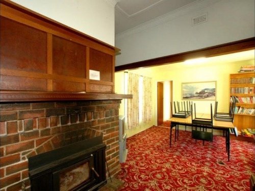 The dining room originally featured dark timber panels and retro carpet.