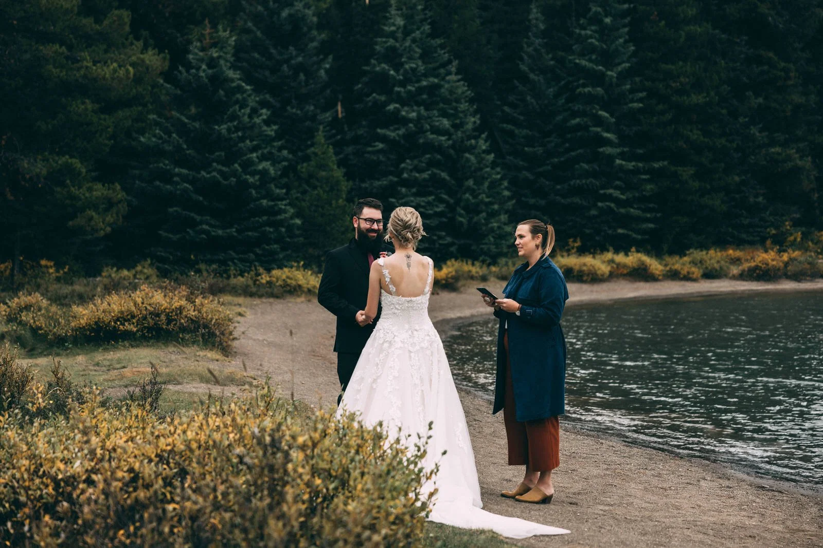 officiant marrying a couple at maligne lake