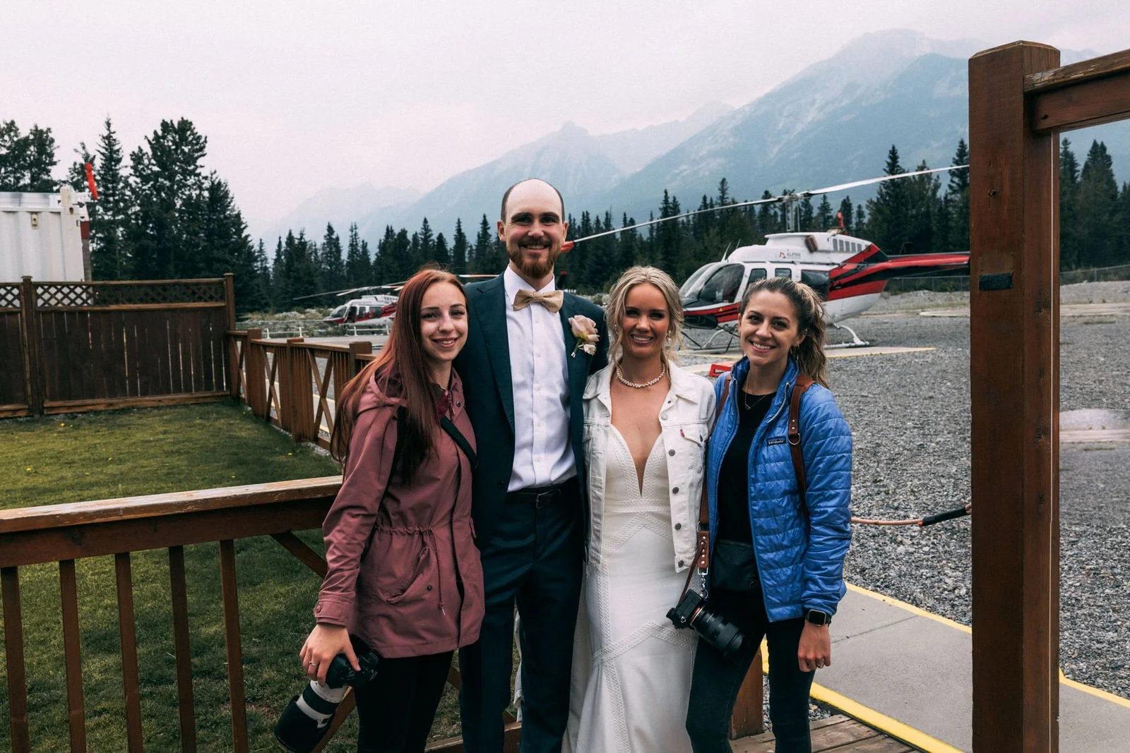 photographer with couple posing for a photo after the helicopter ride