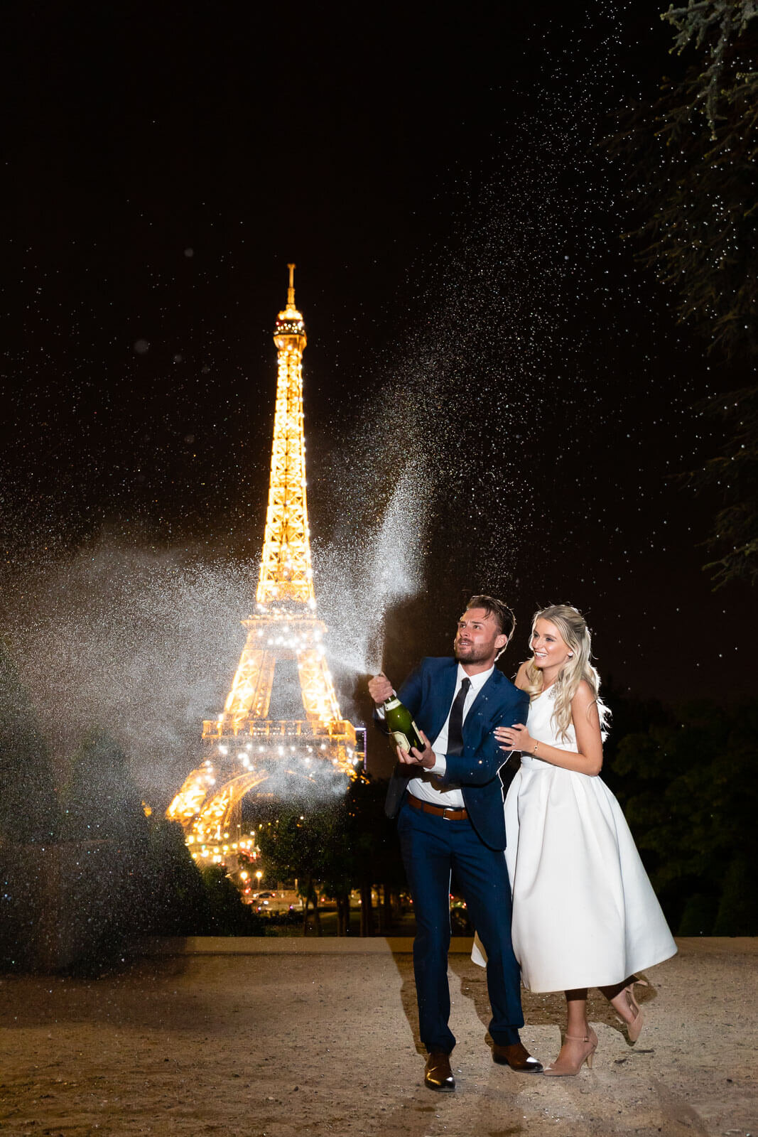 Bride and groom in Paris with champagne Michael Kobler.jpg