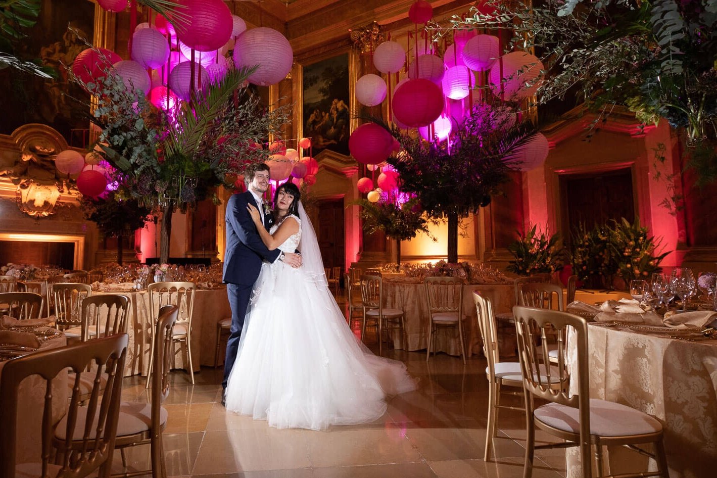 Wedding photographer Vienna at Palais Liechtenstein with bridal couple posing in the decorated ballroom

