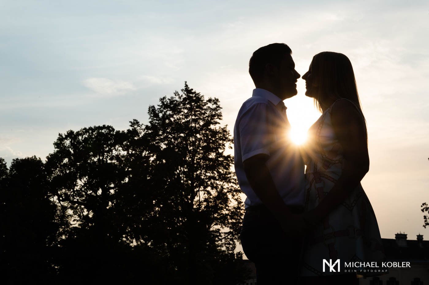 Couple in love at sunset in Laxenburg Palace Park.