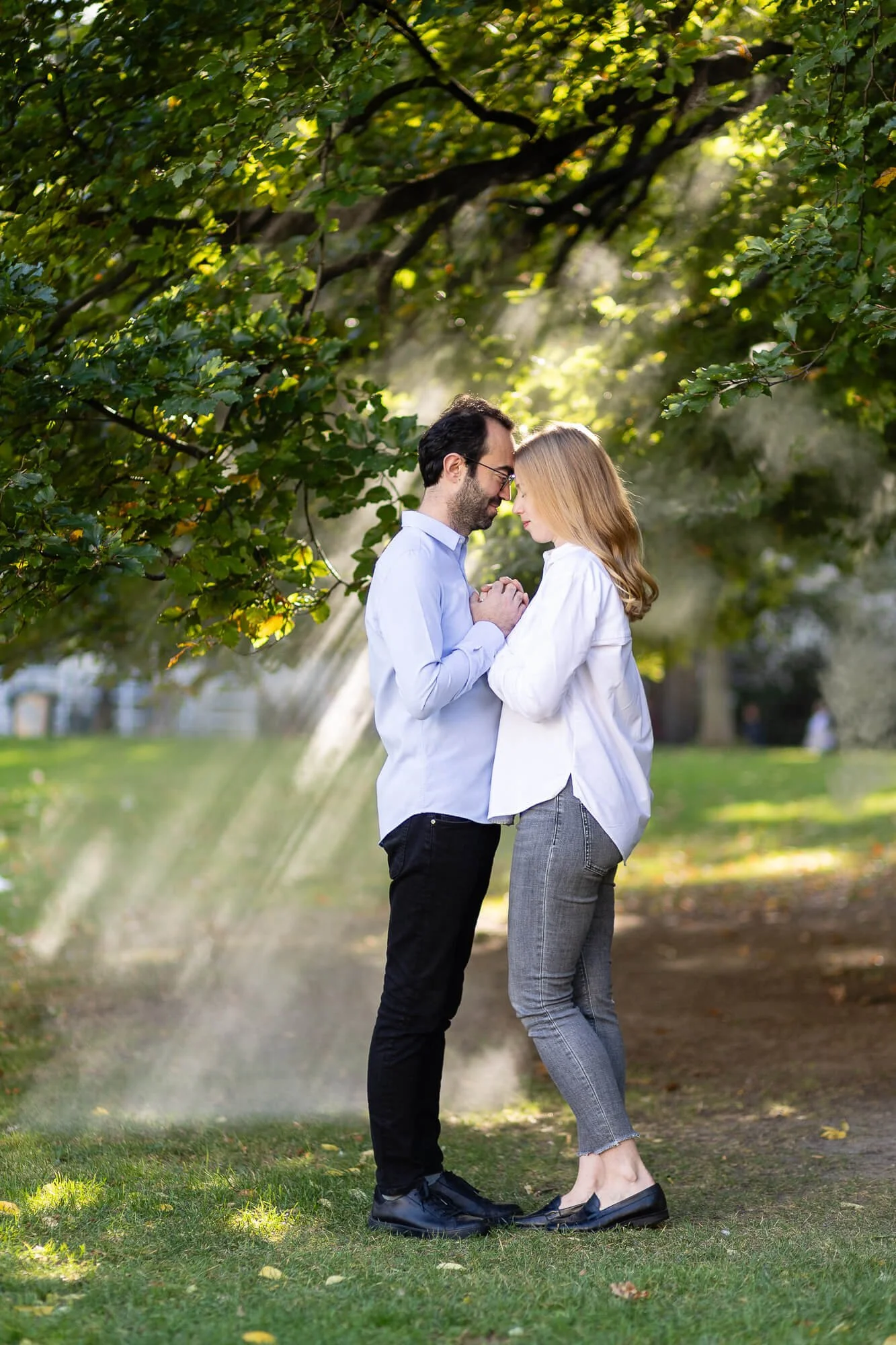 Engagement photo shoot in the early morning with sunbeams in the background.