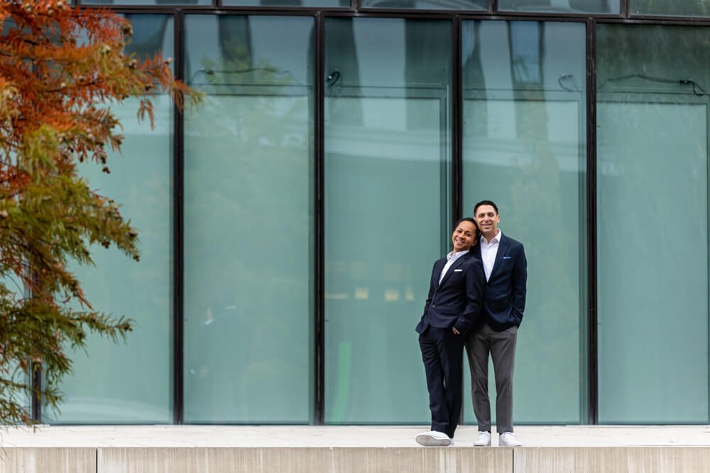 Couple in love in front of a modern glass façade