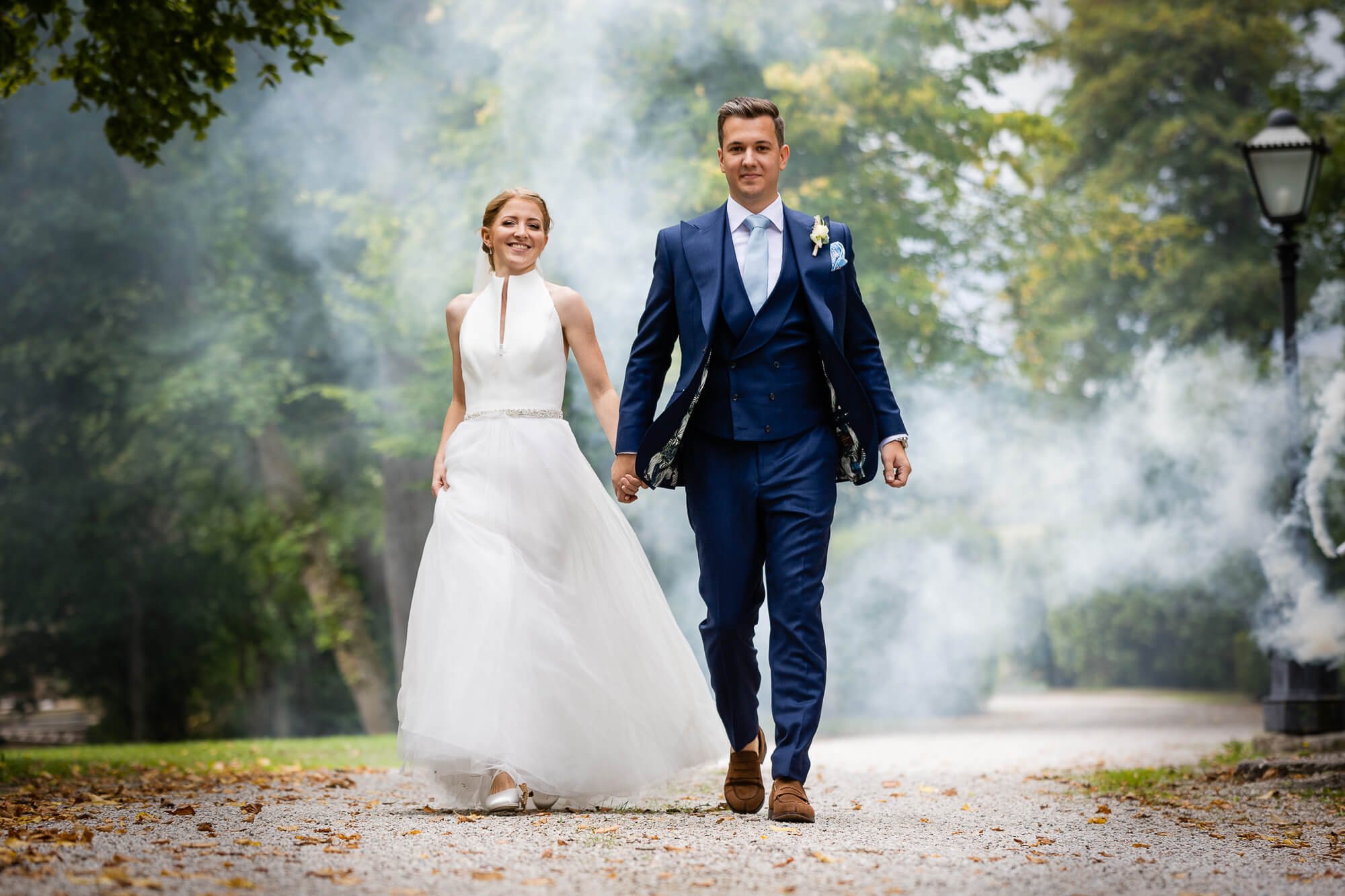 Bridal couple photo in a green park with smoke monkey in the background