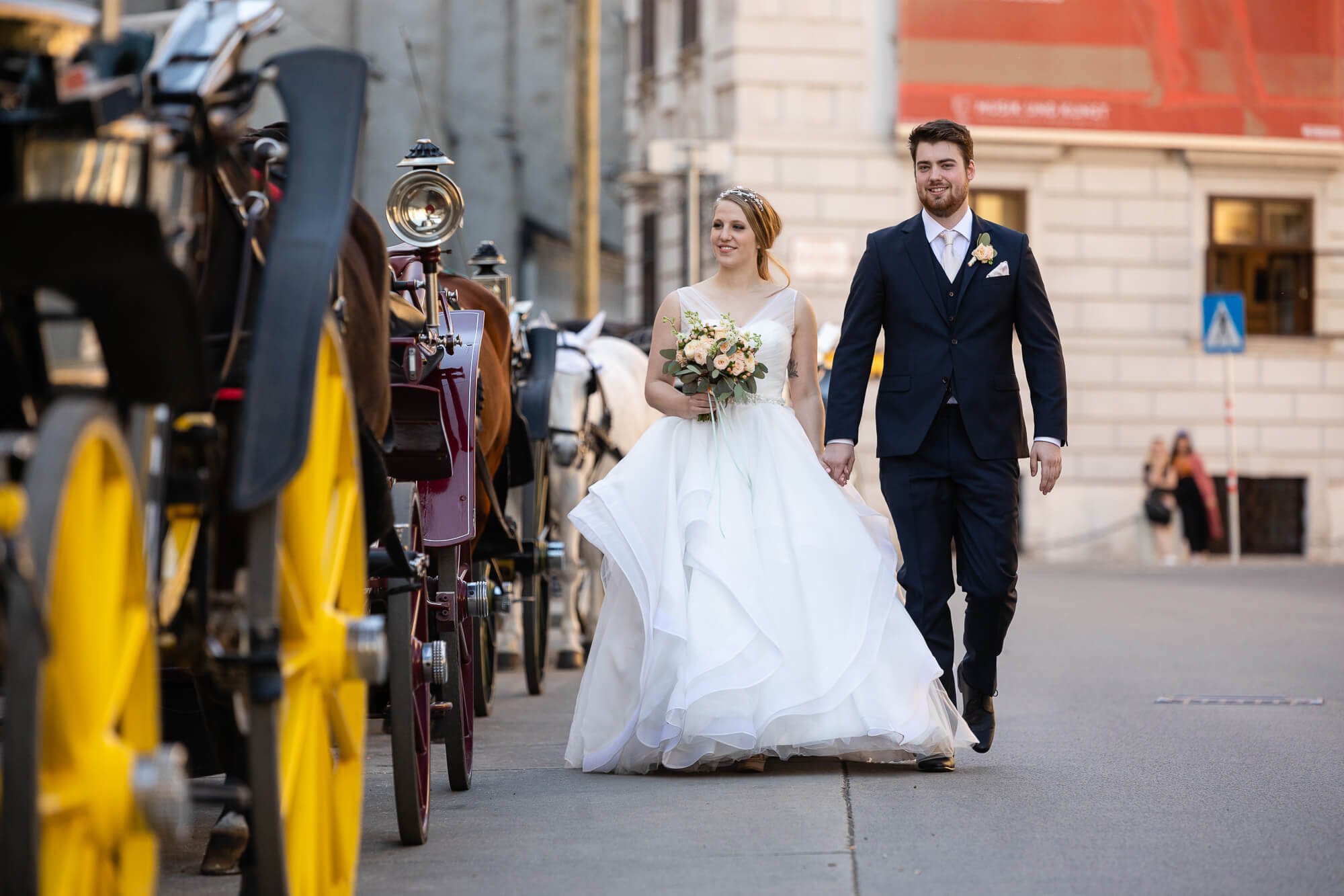 Wedding couple walking along Viennese horse-drawn carriage wedding photographer Vienna