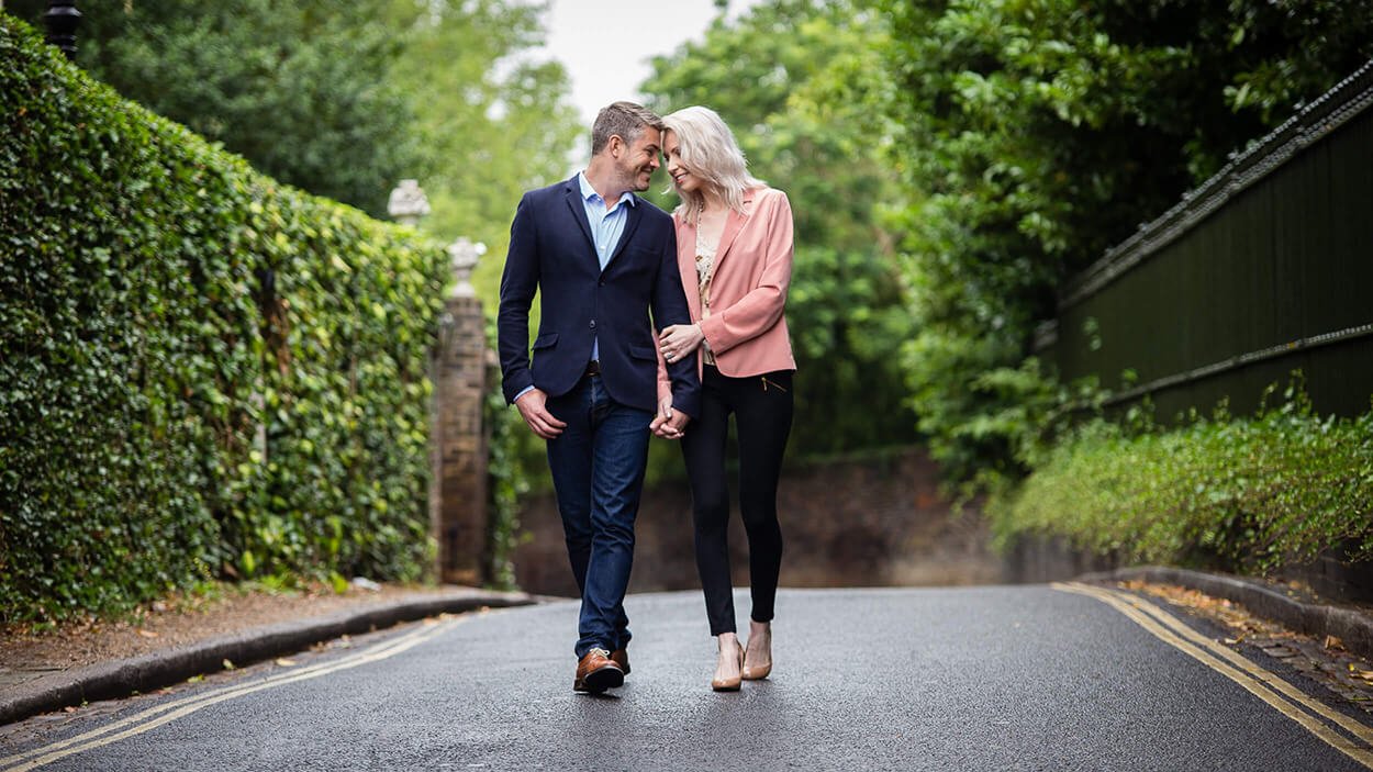 Couple in love in business casual look walking on a street.
