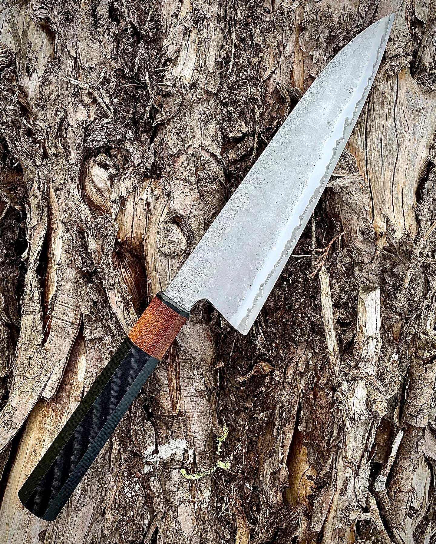 It's been a while, but it's Friday so here here's a new knife after many weeks of no new knives.

240mm Gyuto, stainless clad Shirogami #1, hand forged with only manual tools, water quenched and shaped on stones. The blade has forged hollows and a ha