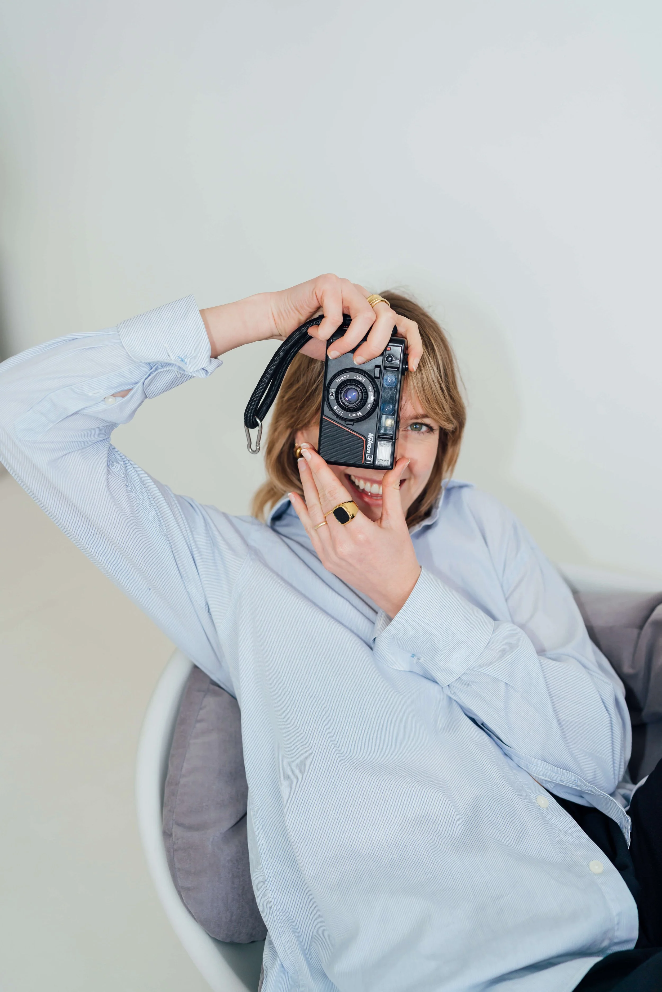 Charlie Britz, wedding photographer in London,, holding a film camera in portrait