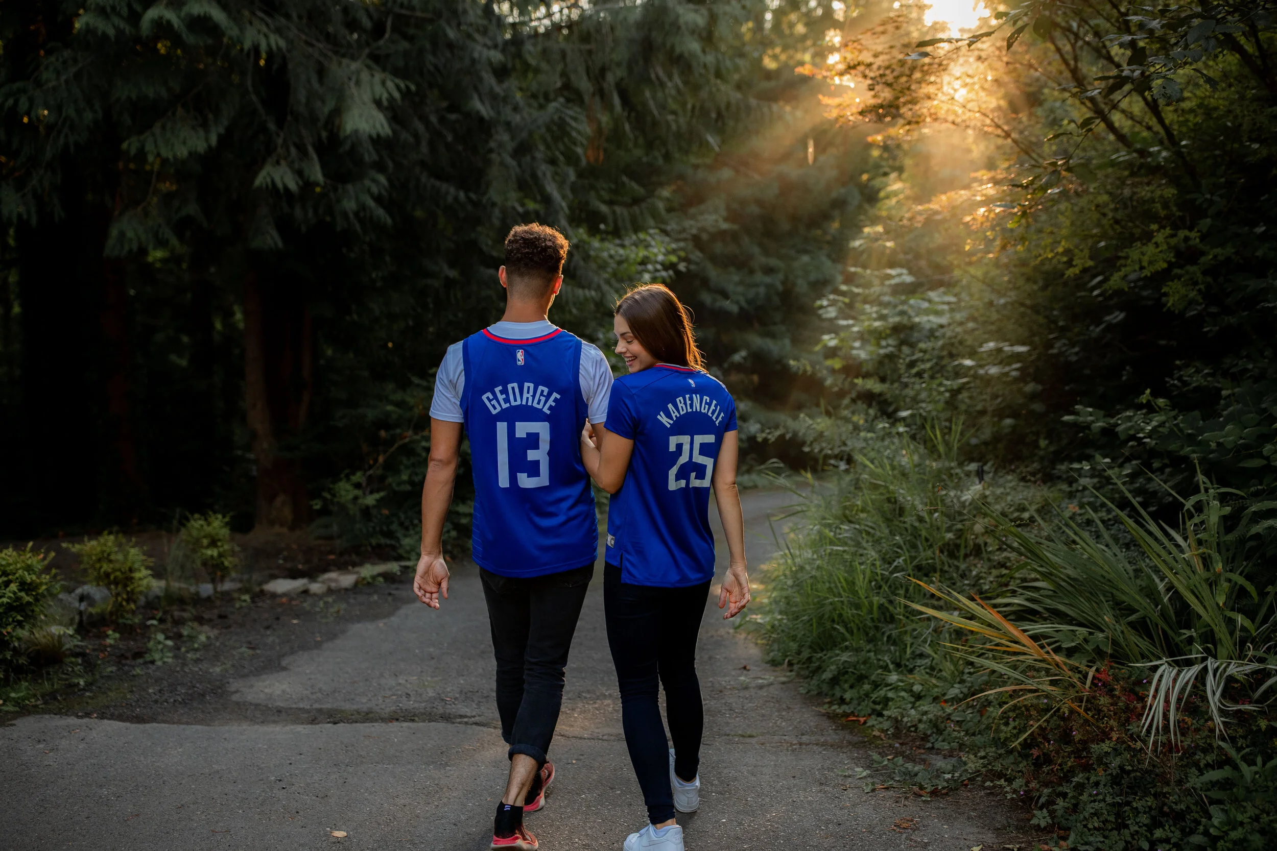 Man and Woman in NBA jerseys walk in woods.jpg