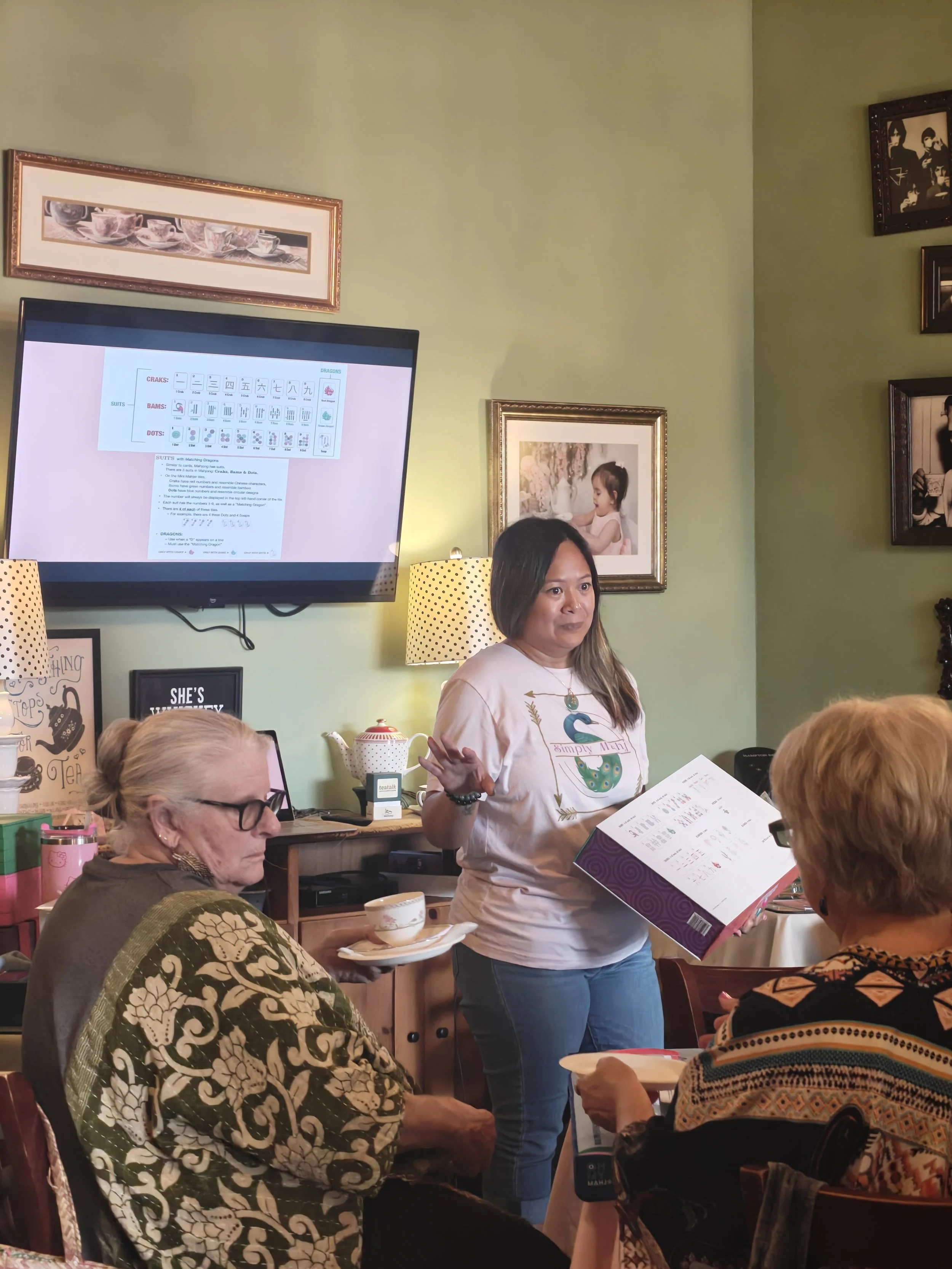 Teacher leading a class on Mahjong at McHugh Tea Room