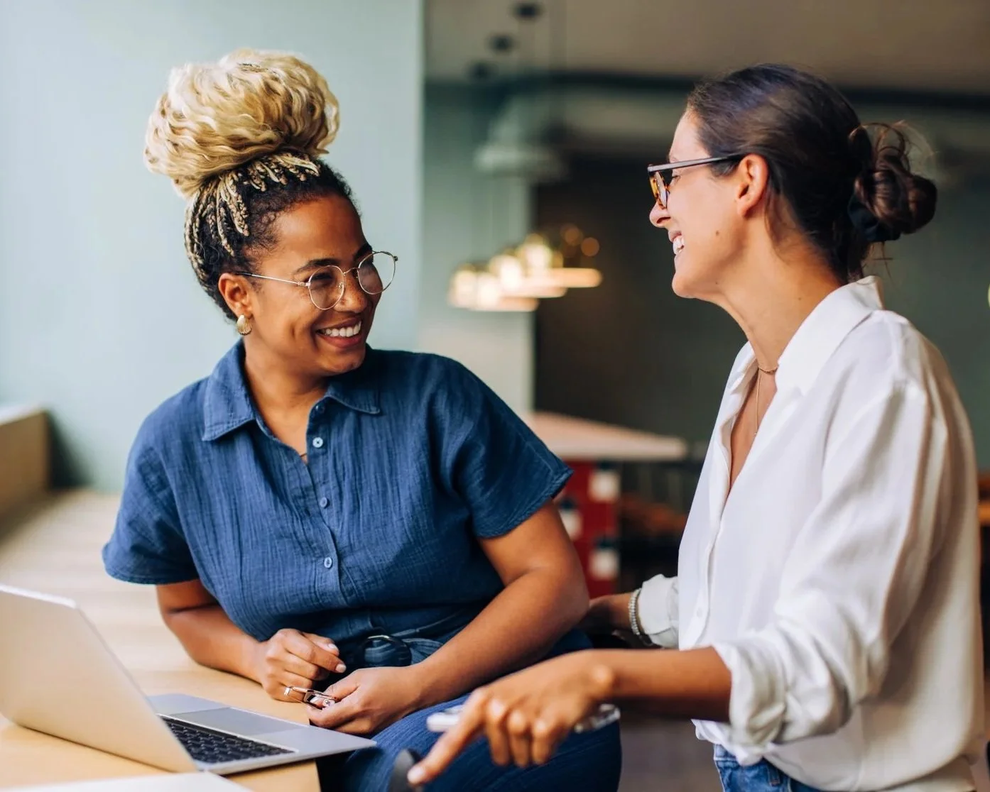 Two professional women talking and laughing