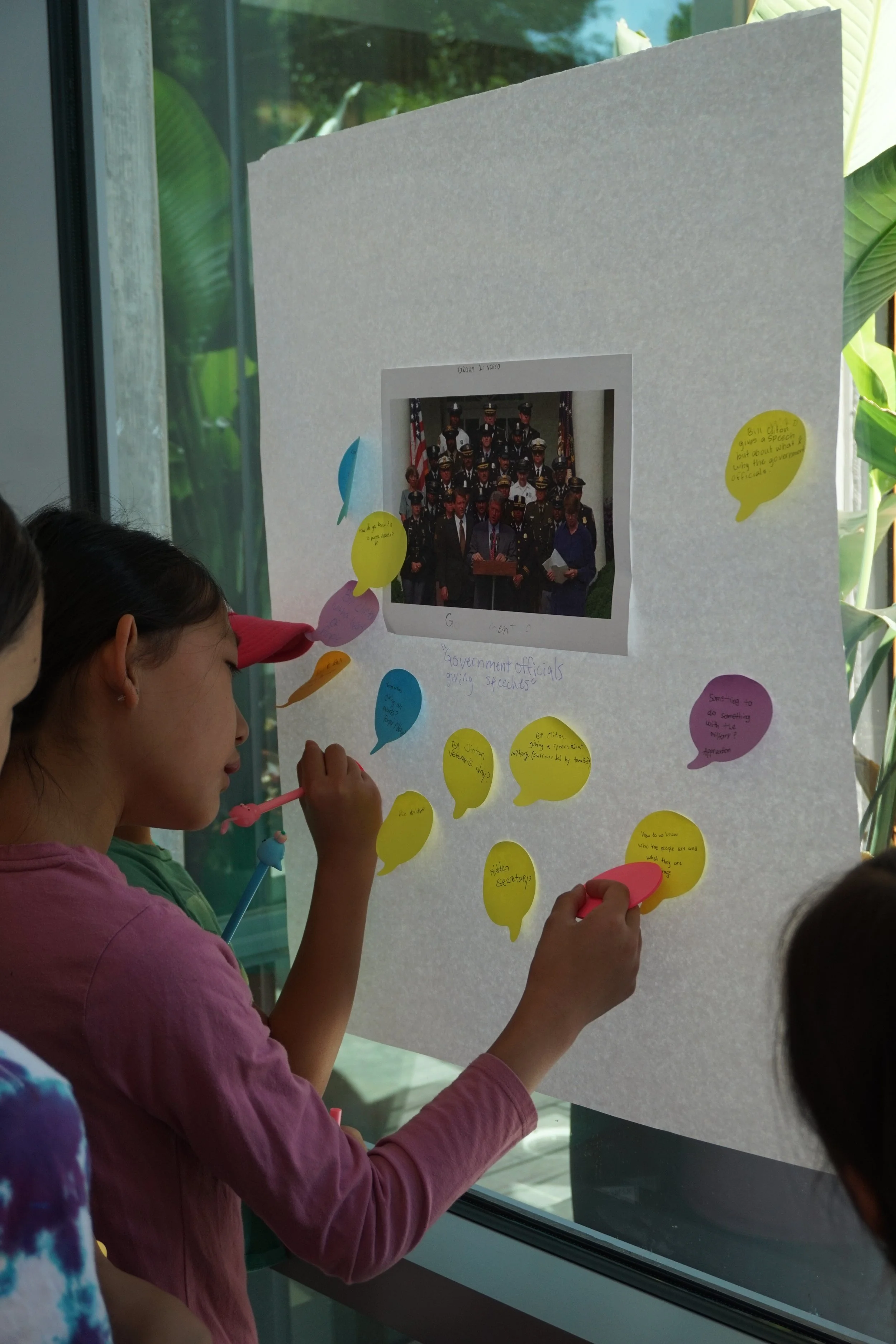 Students writing during gallery walk at AGI summer program