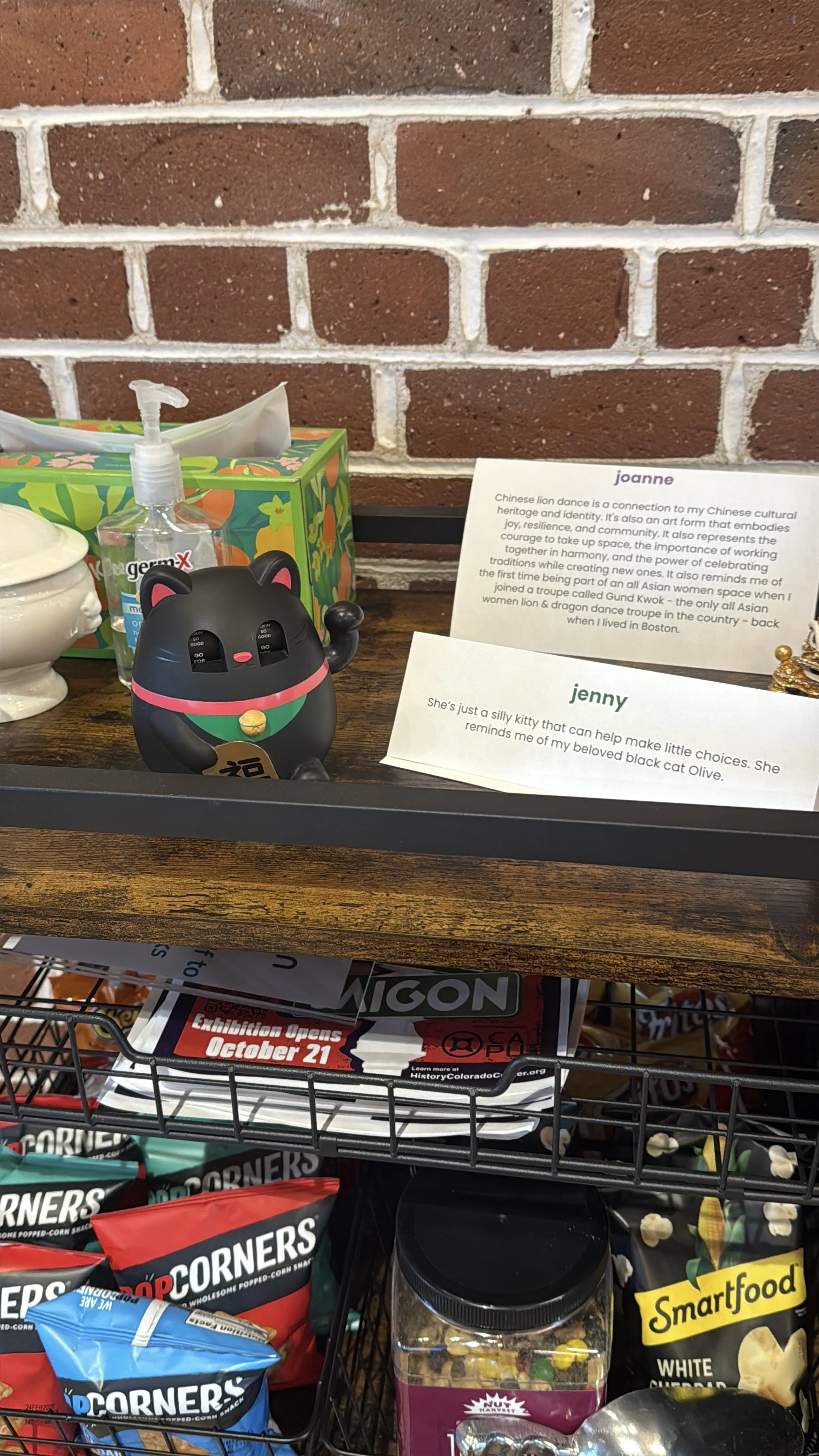  lucky cat 8-ball on table with a paper of its story on a table with snacks 