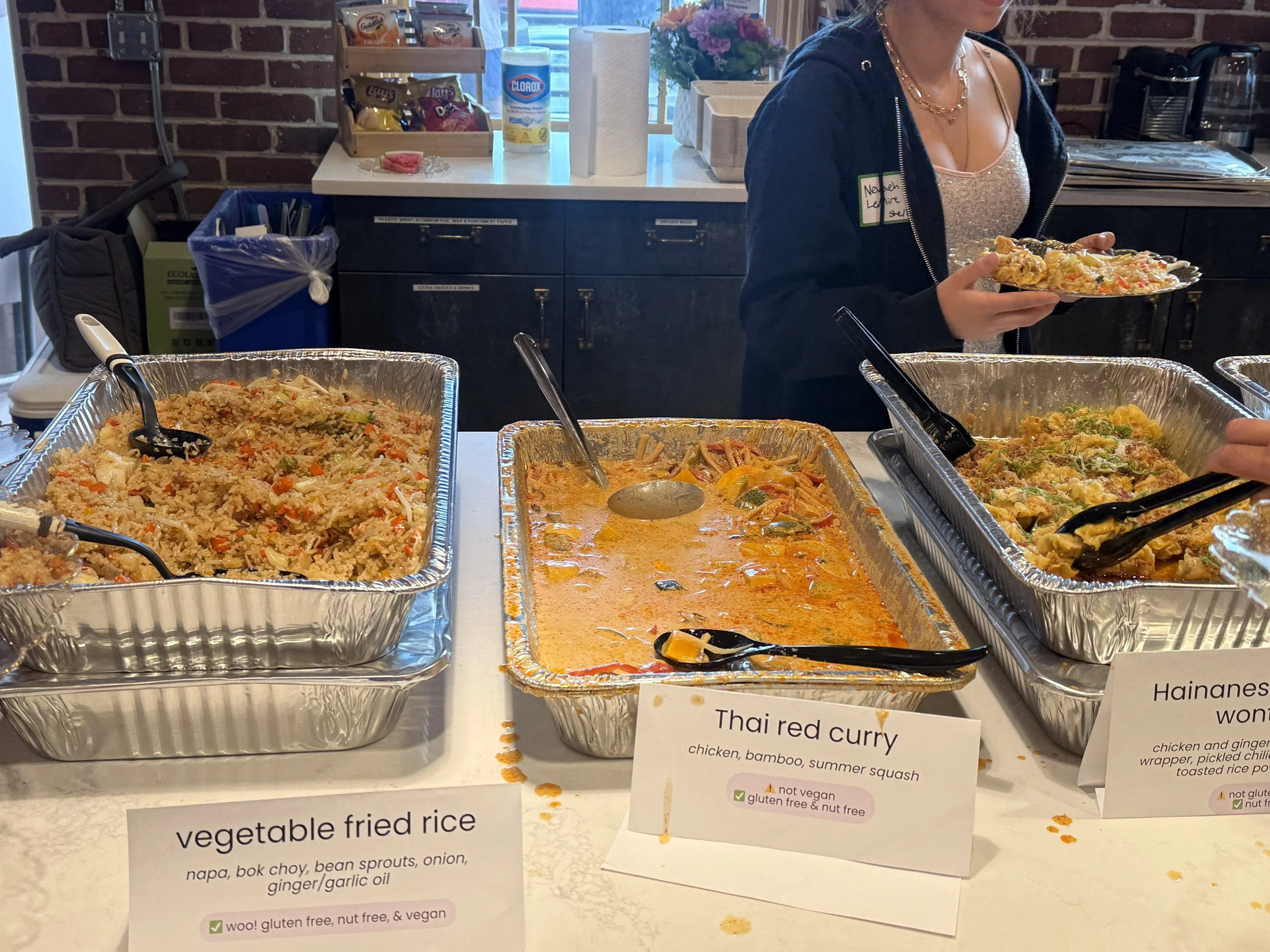  catering from Yuan Wonton in trays at kitchen island 