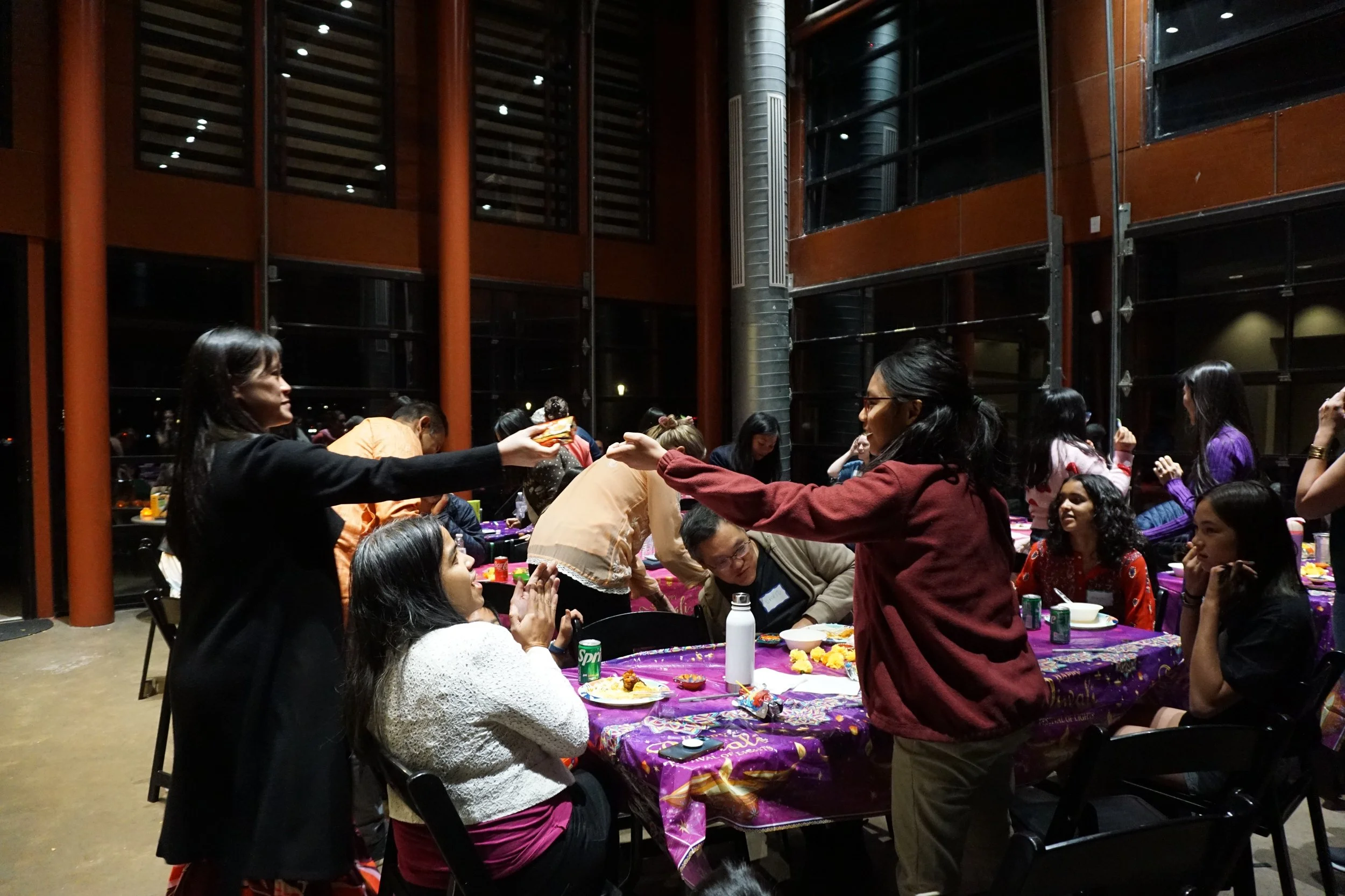  Student receives prize from Housie activity at AGI Diwali CelebrAsian 