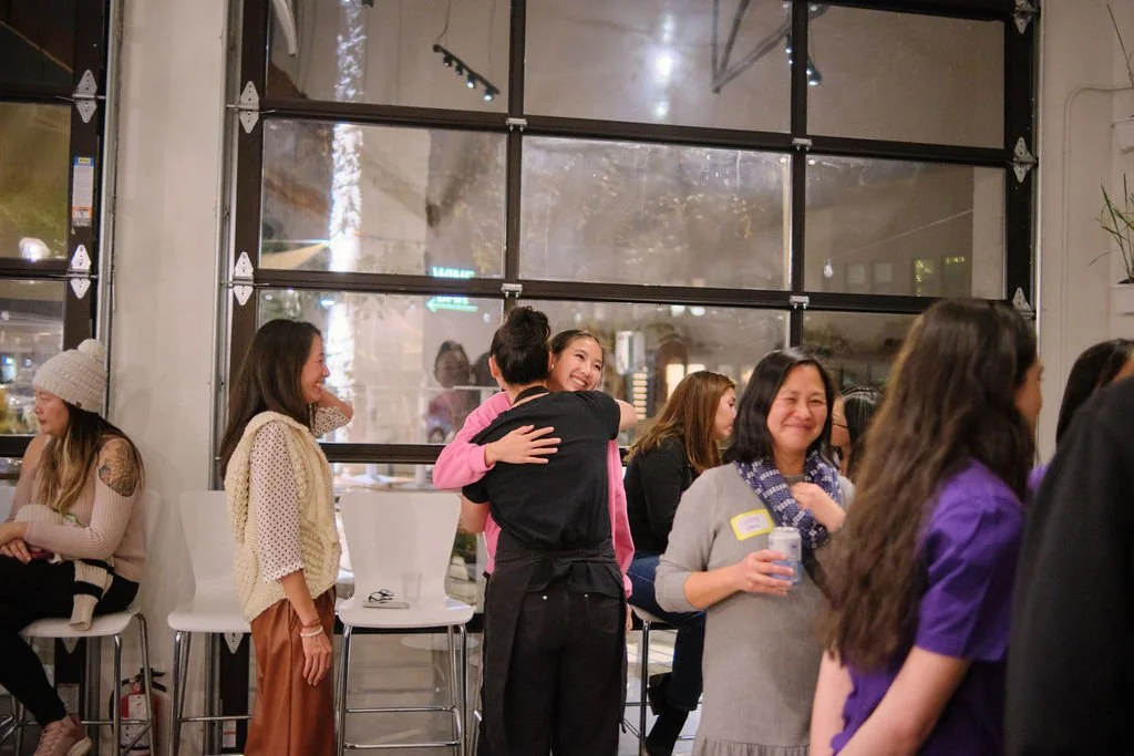  Elaine Yang and daughter hugs Chef Penelope Wong of Yuan Wonton at AGI at AppreciAsian 2025 hosted at Yuan Wonton 
