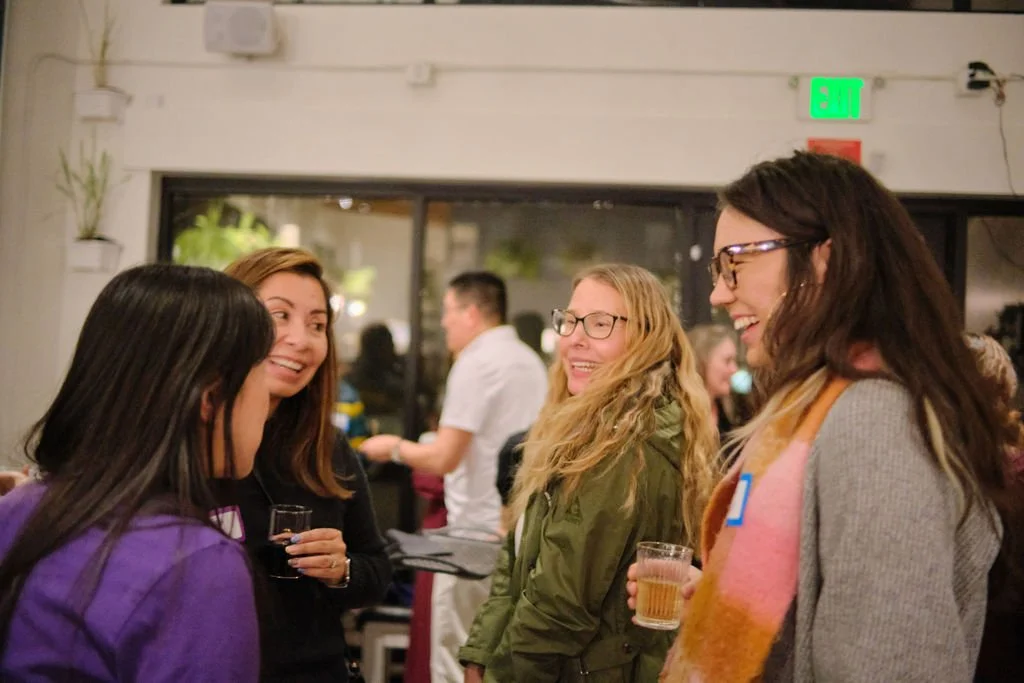  Community members in laughter and conversation at AGI AppreciAsian 2025 hosted at Yuan Wonton 