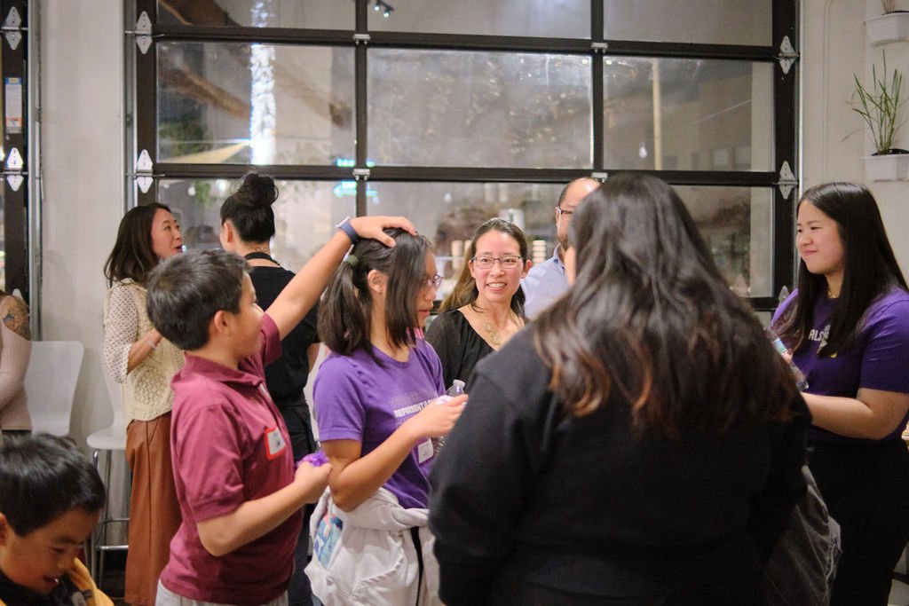  AGI student Azalea and family, community members, and staff at AGI AppreciAsian 2025 hosted at Yuan Wonton 
