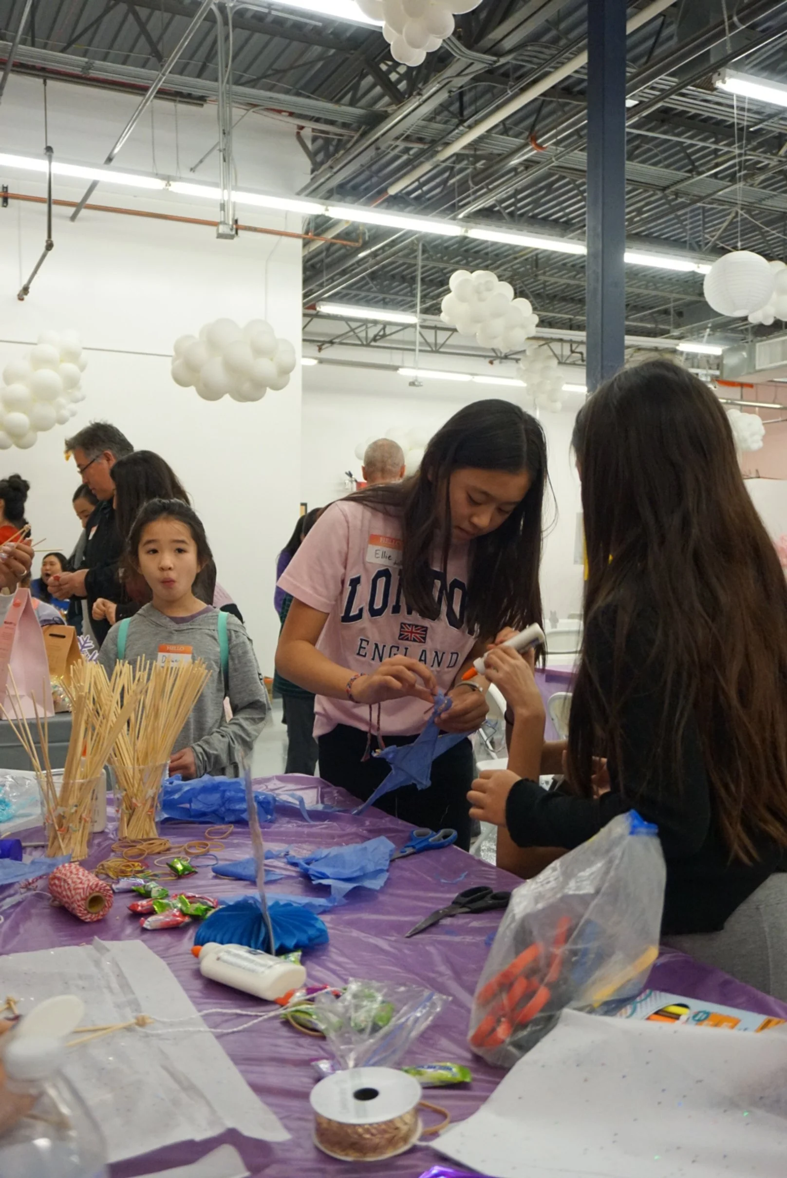  AGI students in conversation creating Filipino Parol at AGI Holiday Social 