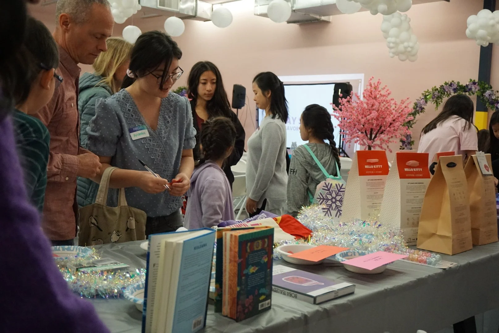  Students and families look at raffle prize table at AGI Holiday Social 