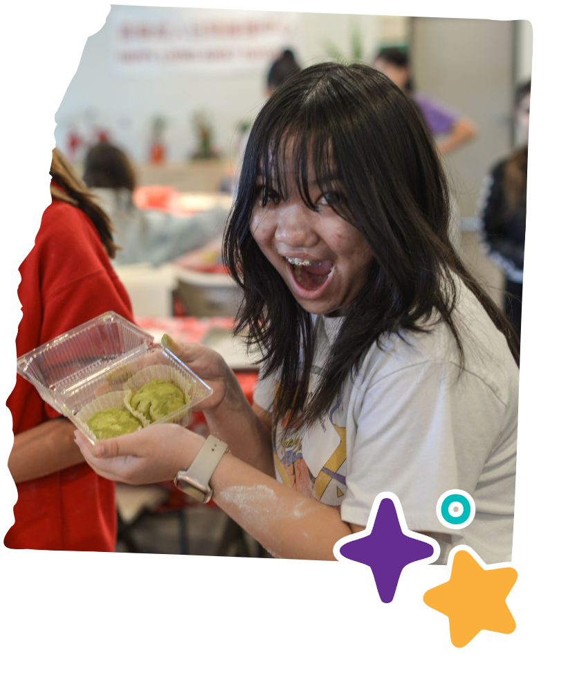 asian american native hawaiian pacific islander girl holding mochi she made during asian girls ignite mochi making event