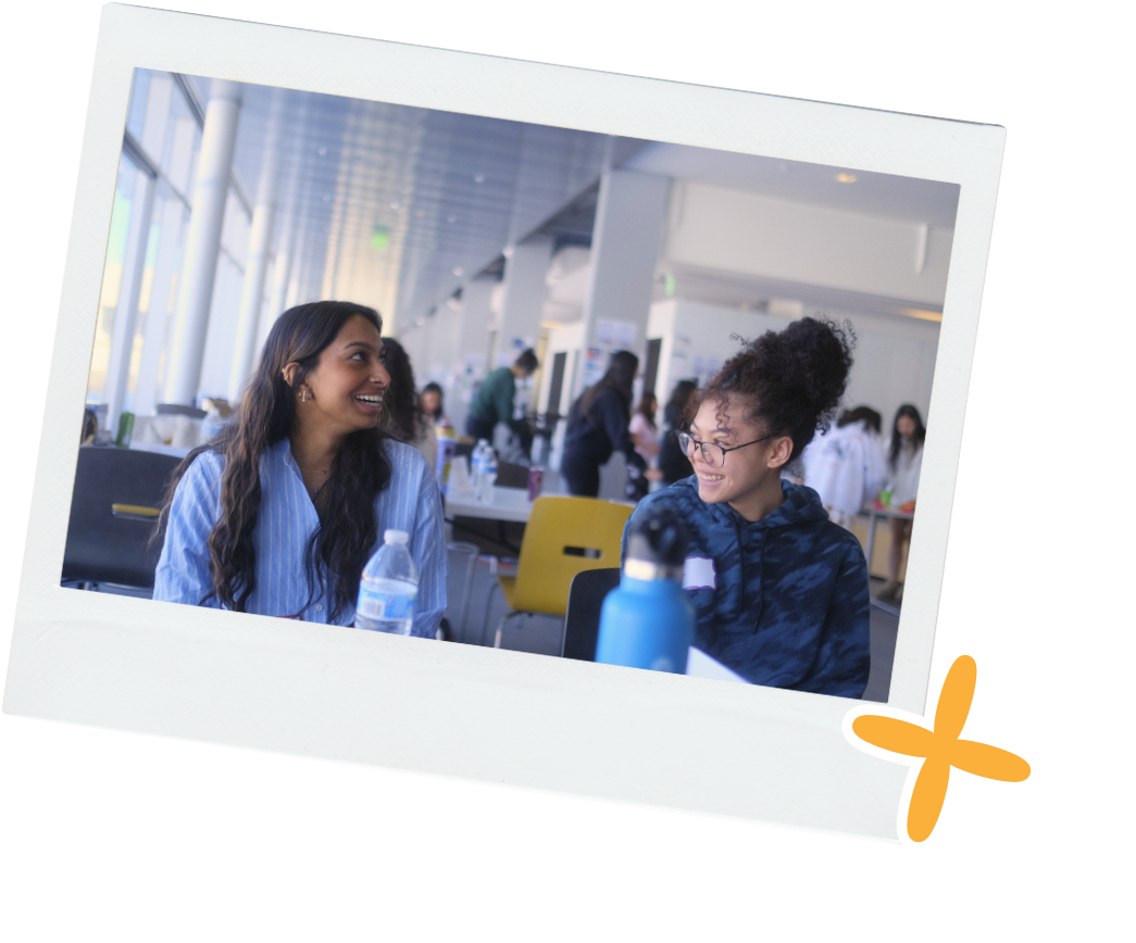 biracial asian american girl talking to south asian storyteller from colorado school of mines