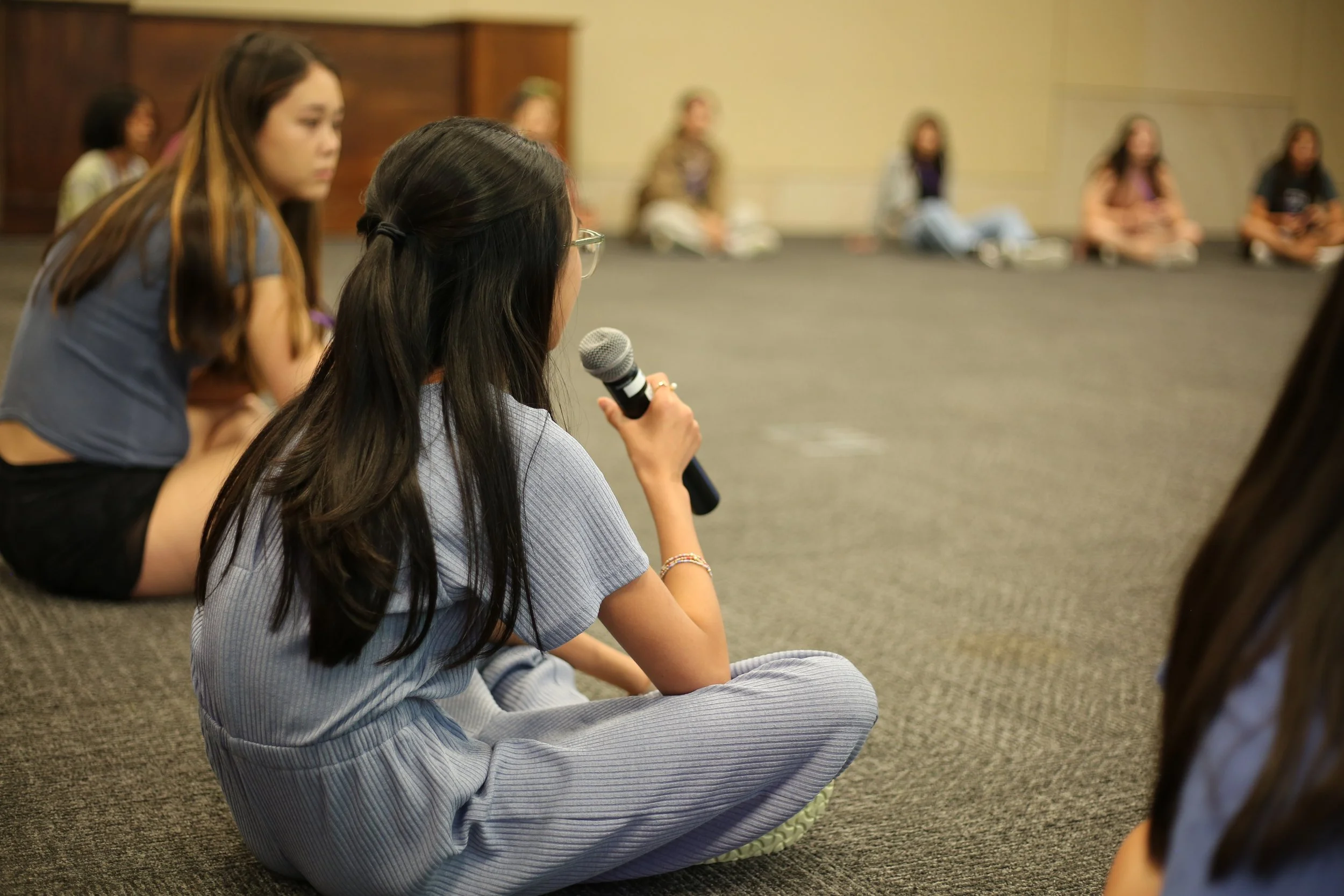 asian american girl holding microphone