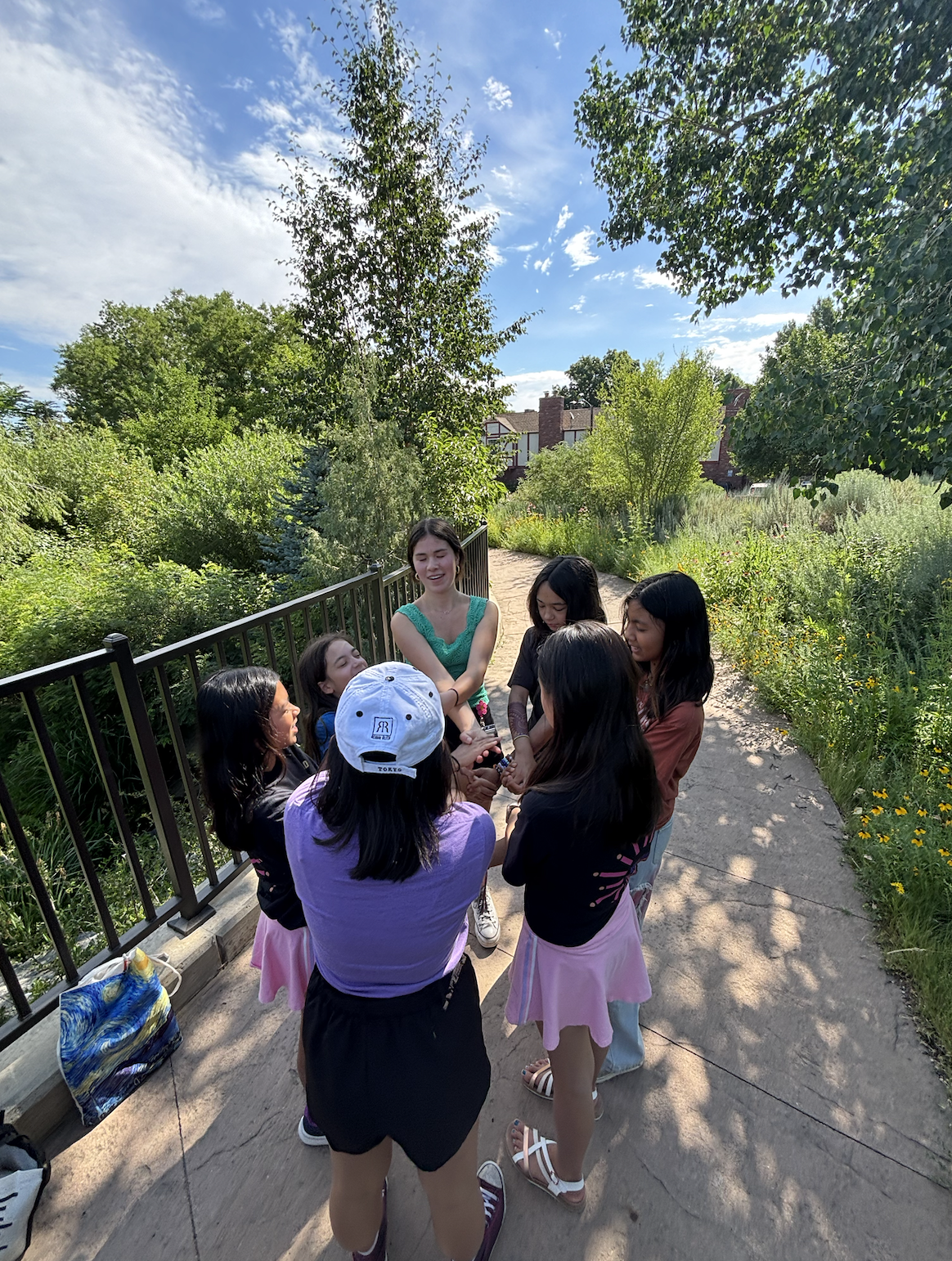 asian american high school student doing ice breaker activity as a camp counsellor with their grade 7 group