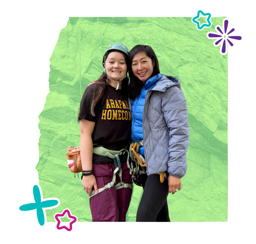 asian american girl rock climbing with asian american mentor in colorado