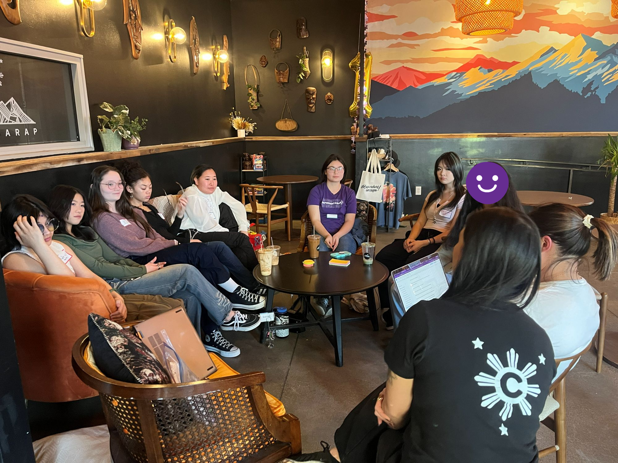  Group of high school students sit in a circle on chairs at Coffee Sarap in Denver listening to owners speak.  