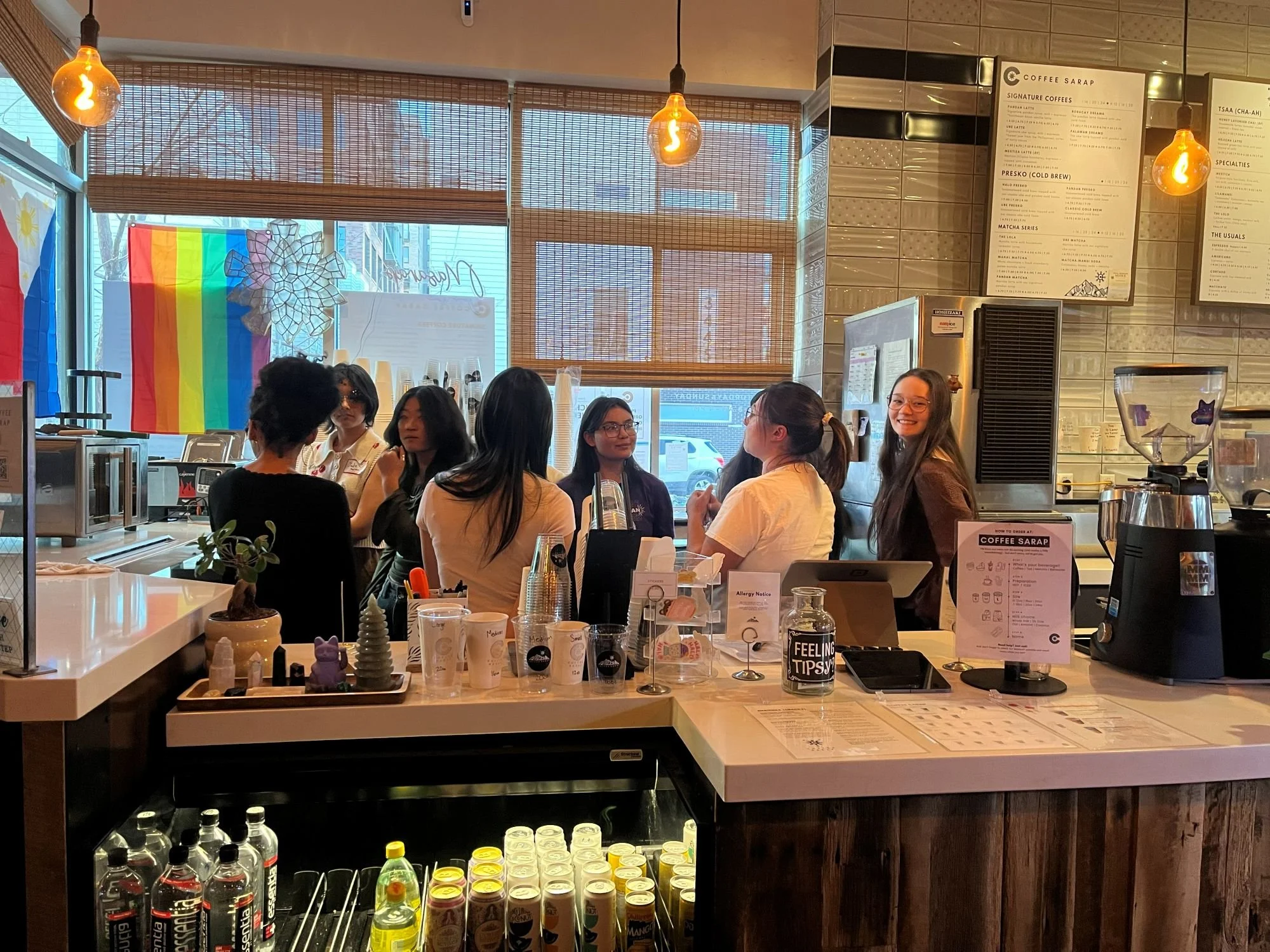  Group of high school participants gather in the barista area of Coffee Sarap as they receive training and introductions to how to use the equipment. 
