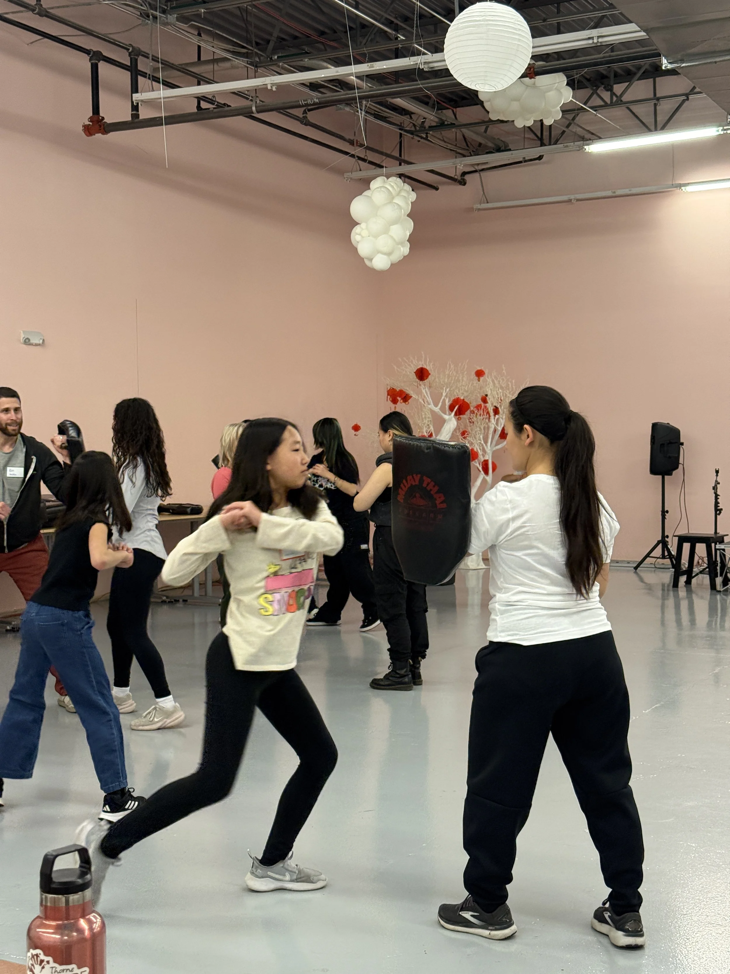  Student and families go through karate exercises and warm-ups at Generational Healing with Asian Girls Ignite at the Social Fabric Hub 