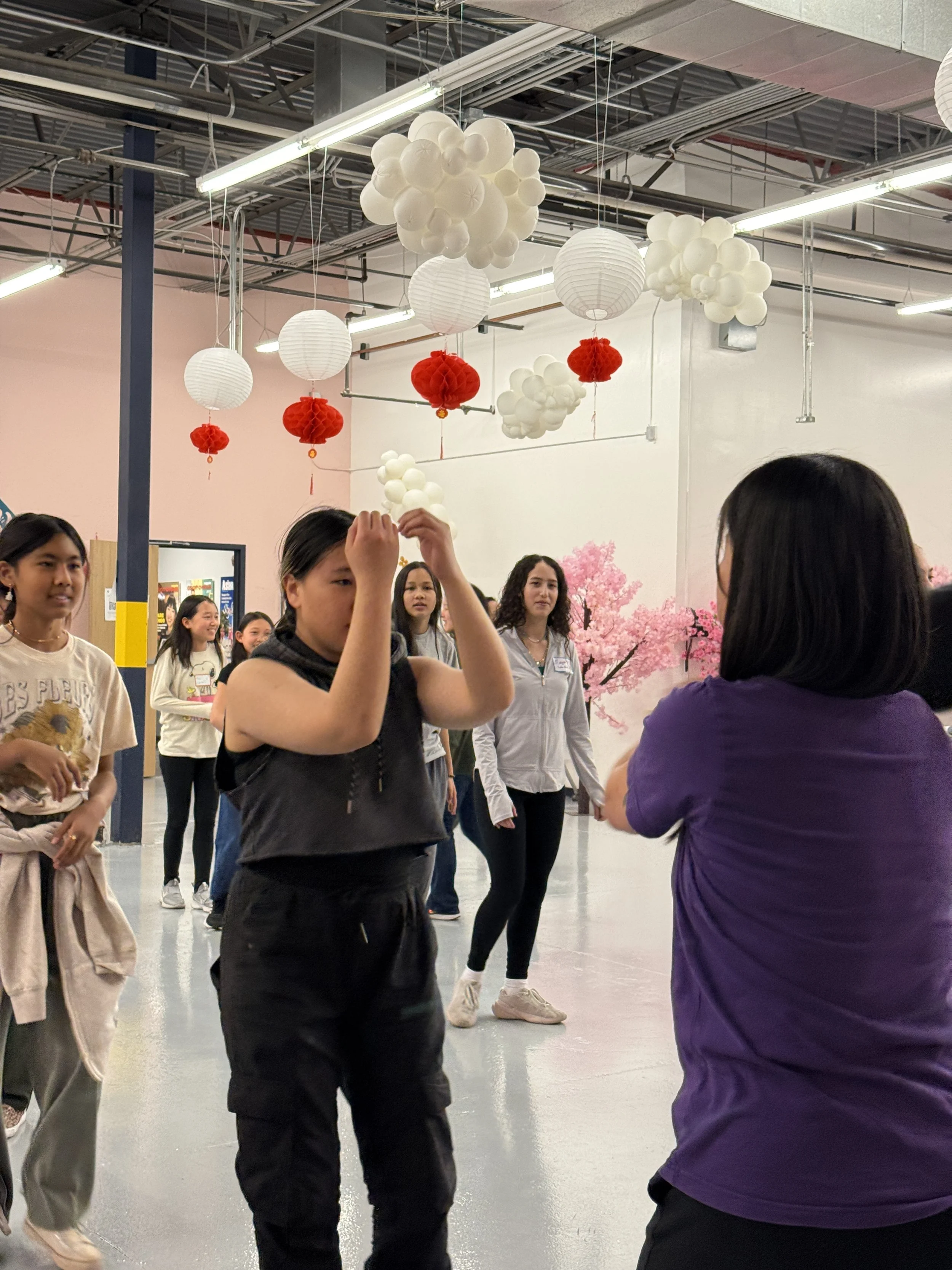  Student and families go through karate exercises and warm-ups at Generational Healing with Asian Girls Ignite at the Social Fabric Hub 