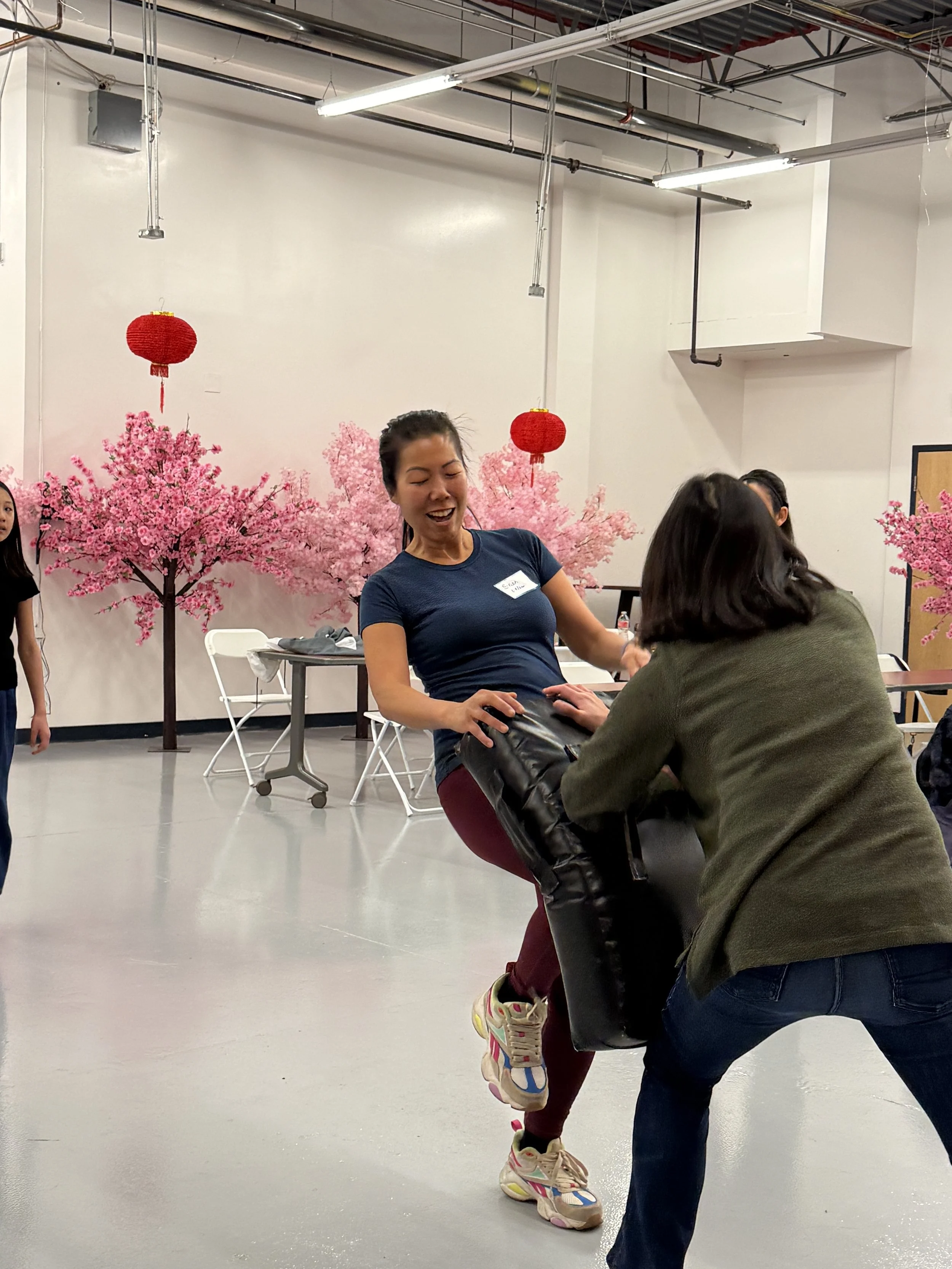  Student and families go through karate exercises and warm-ups at Generational Healing with Asian Girls Ignite at the Social Fabric Hub 