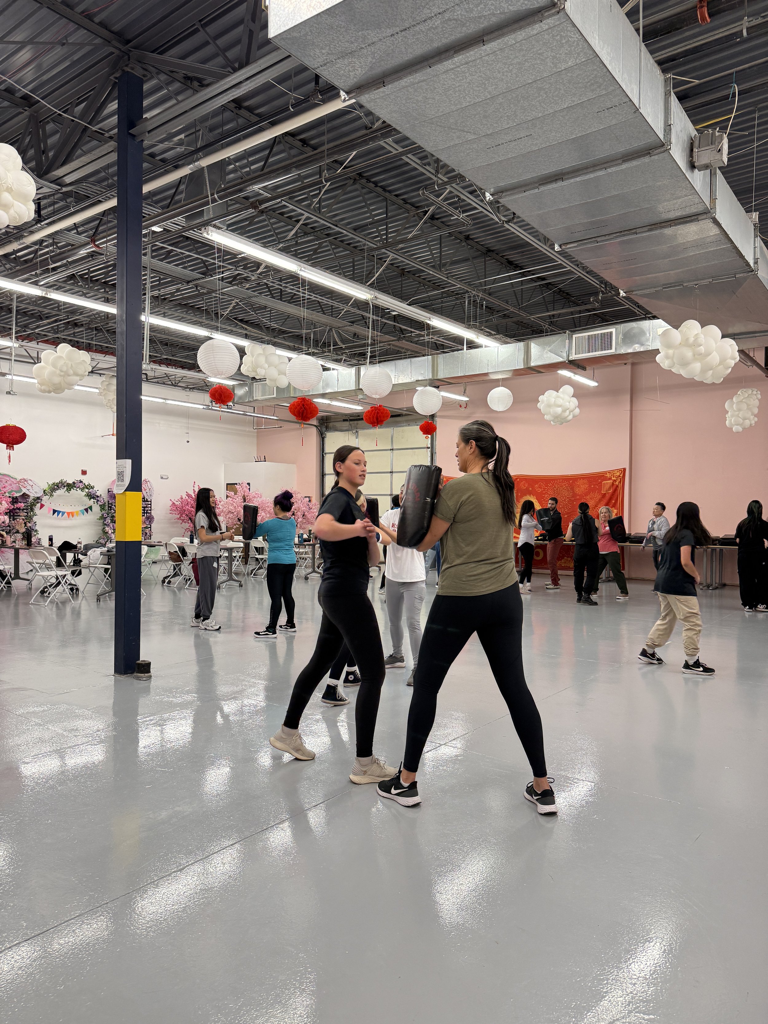  Student and families go through karate exercises and warm-ups at Generational Healing with Asian Girls Ignite at the Social Fabric Hub 