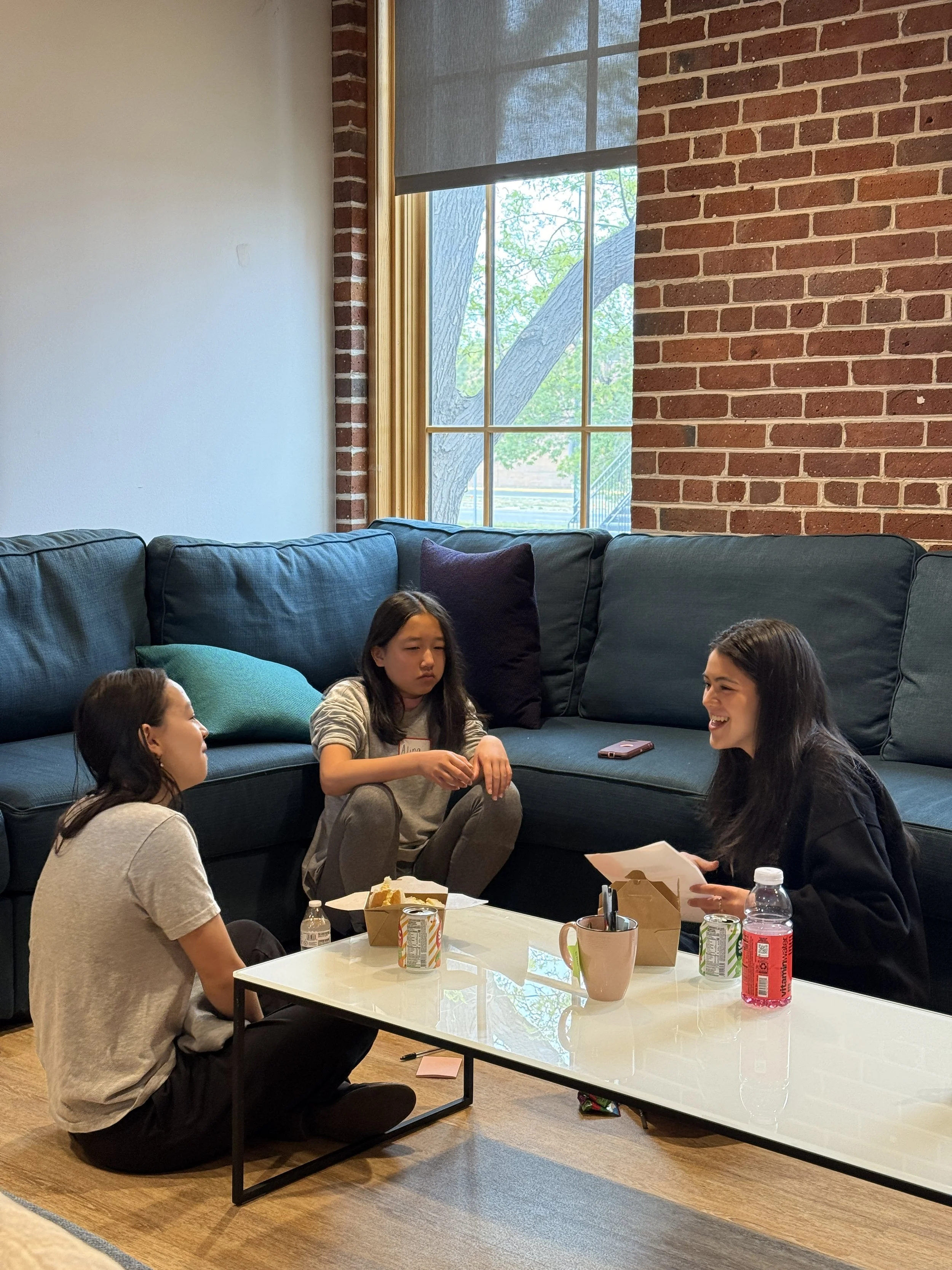  High school mentor speaks with middle school mentees at event with lunch 