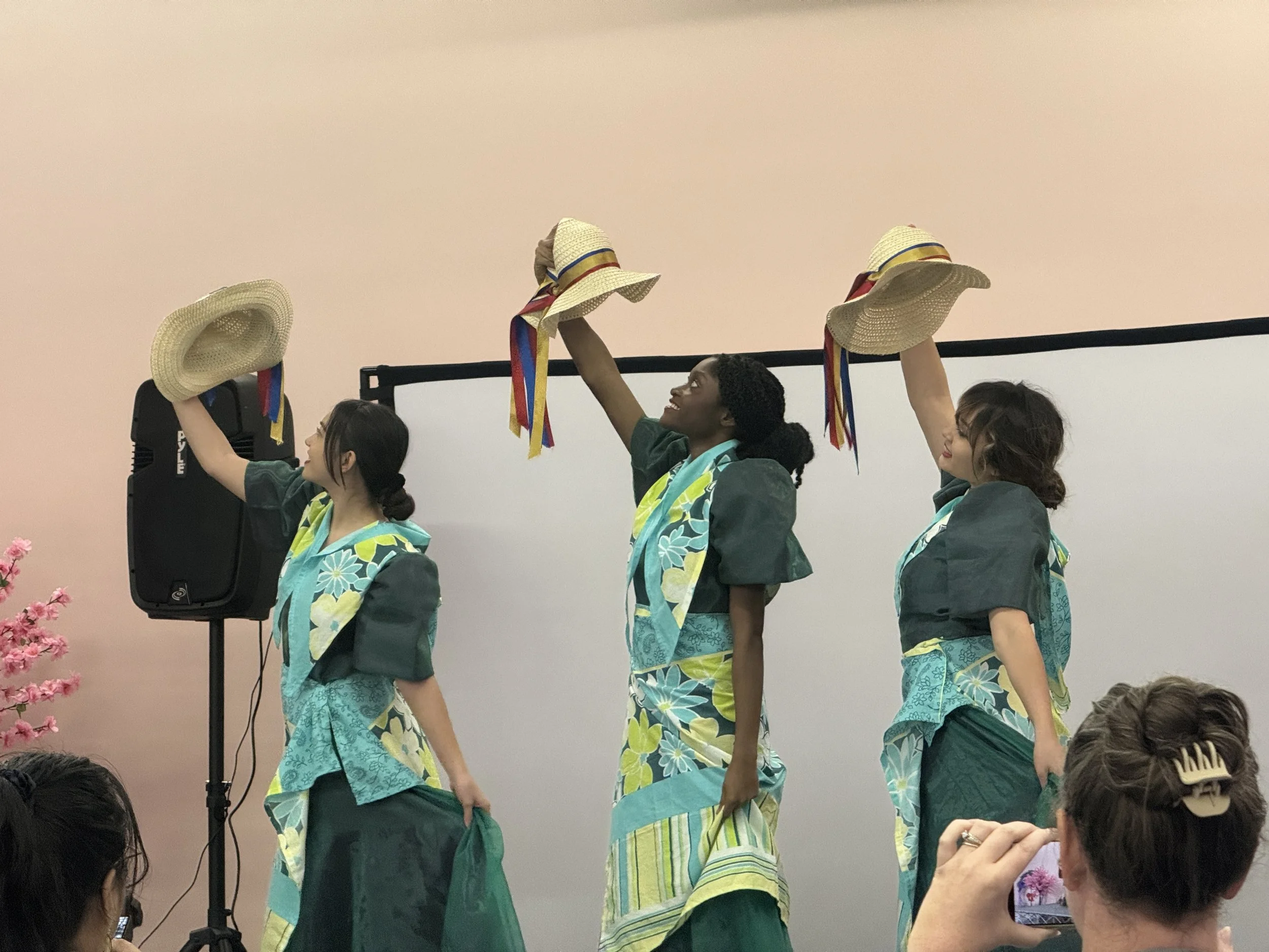 Padayon Cultural FACC perform traditional Filipino Subli dance on stage in light pink room