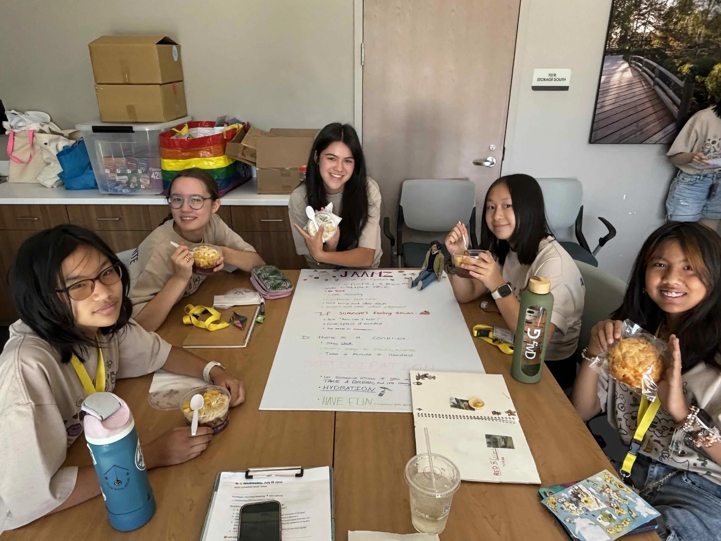 Students posing with their choice of pastry and smoothie bowl from bowl society denver